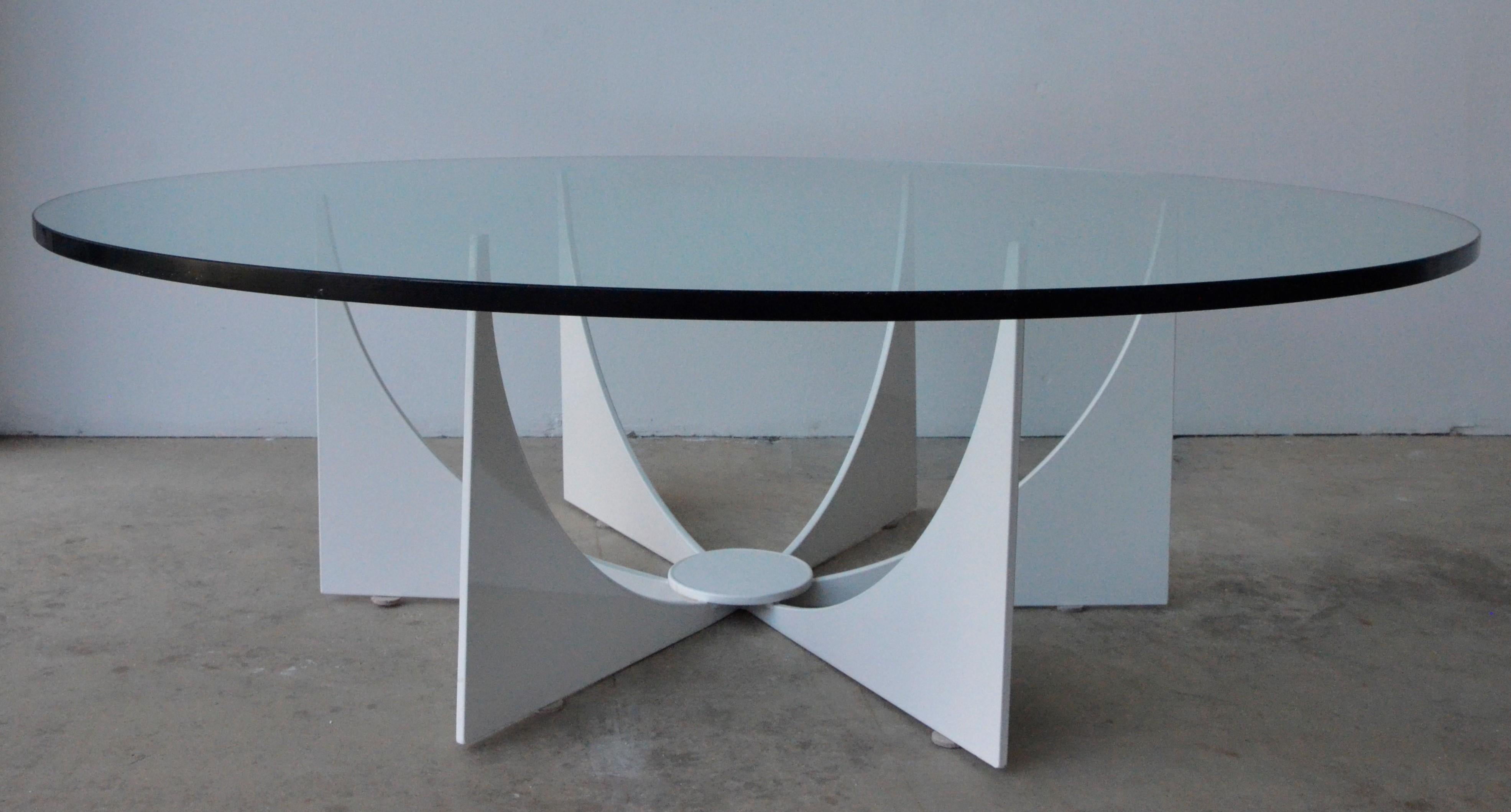 Offered is a newly powder-coated in a creamy white steel atomic design base with a round glass top cocktail or coffee table in the style of Donald Drumm. This Drumm style table is an iconic design. The powder coating and glass make the table perfect