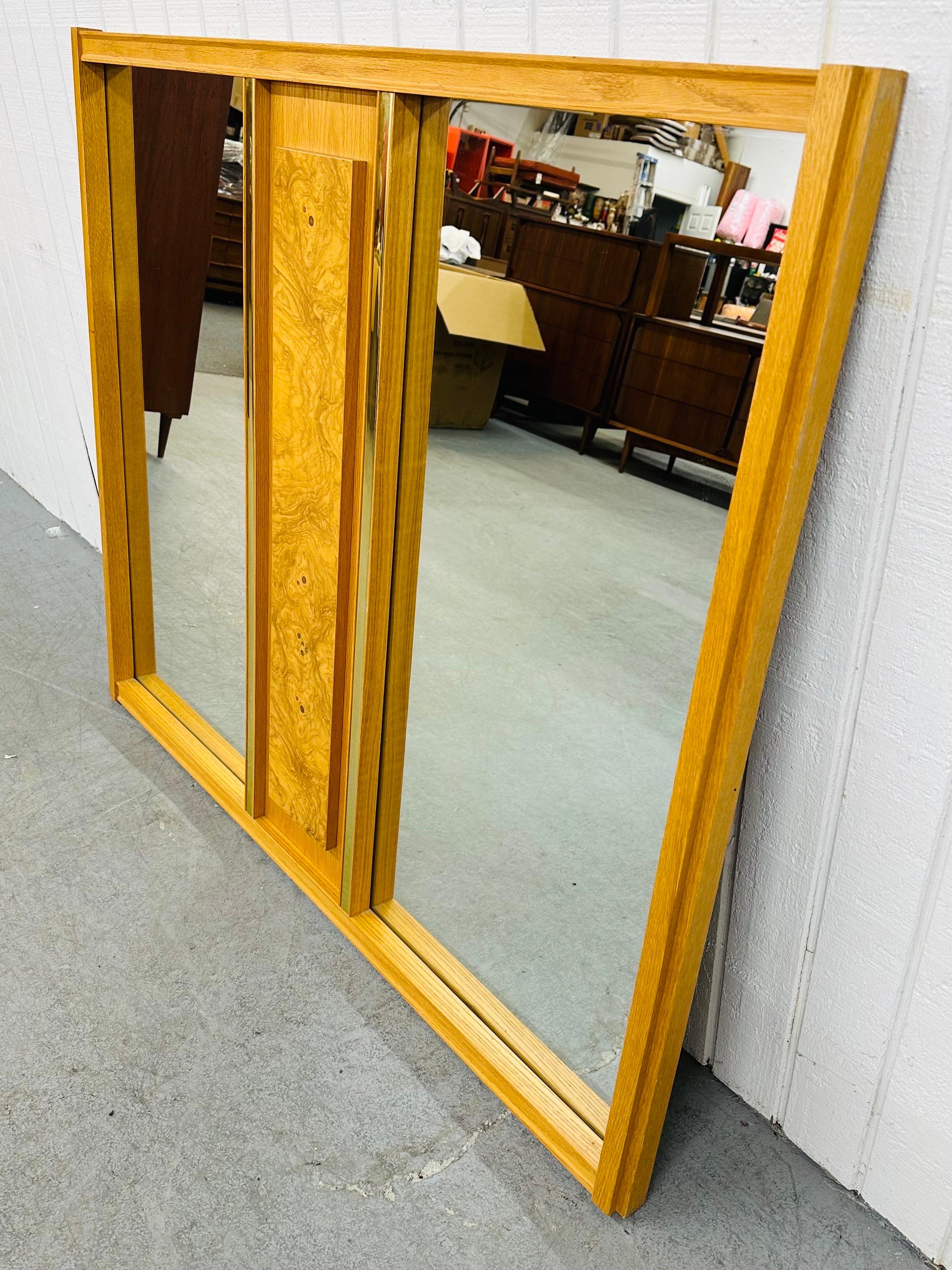 This listing is for a Mid-Century Modern Double Burled Wood Wall Mirror. Featuring a straight line design, rectangular mirror on each side, brutalist burled wood block in the center, brass accents, and a beautiful blonde oak finish. This is an