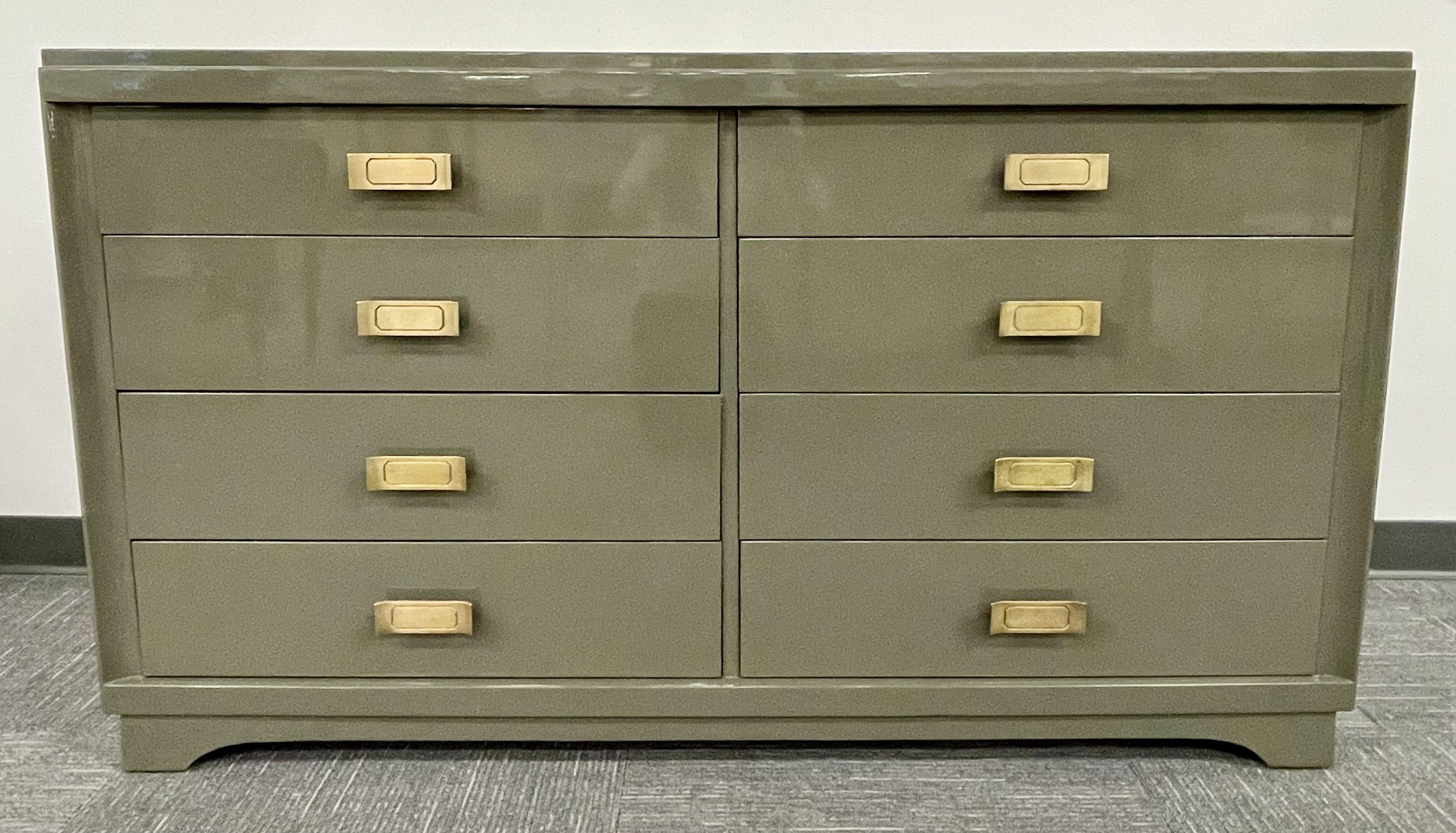 Mid Century Modern Double Chest, Commode or Dresser. A recently lacquered Commode in a fine Olive Green Finish having four by four drawers and gilt gold hardware. The whole resting on Bracket feet and base. Matching Hi Chest, 46H 20D 38W and Small