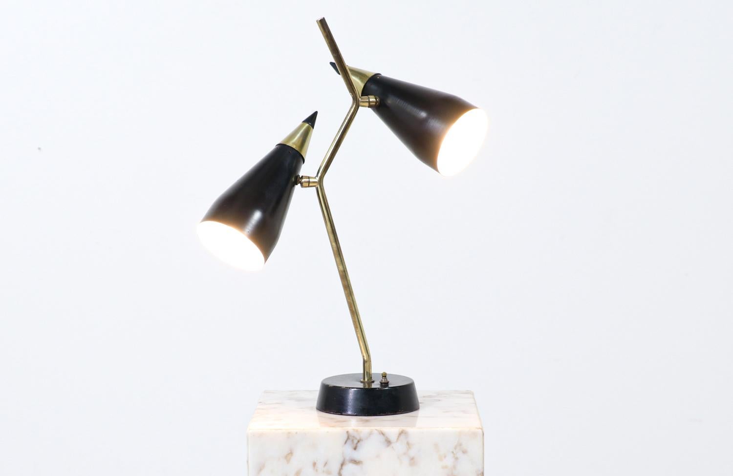 Mid-Century Modern double-cone articulating brass table lamp.