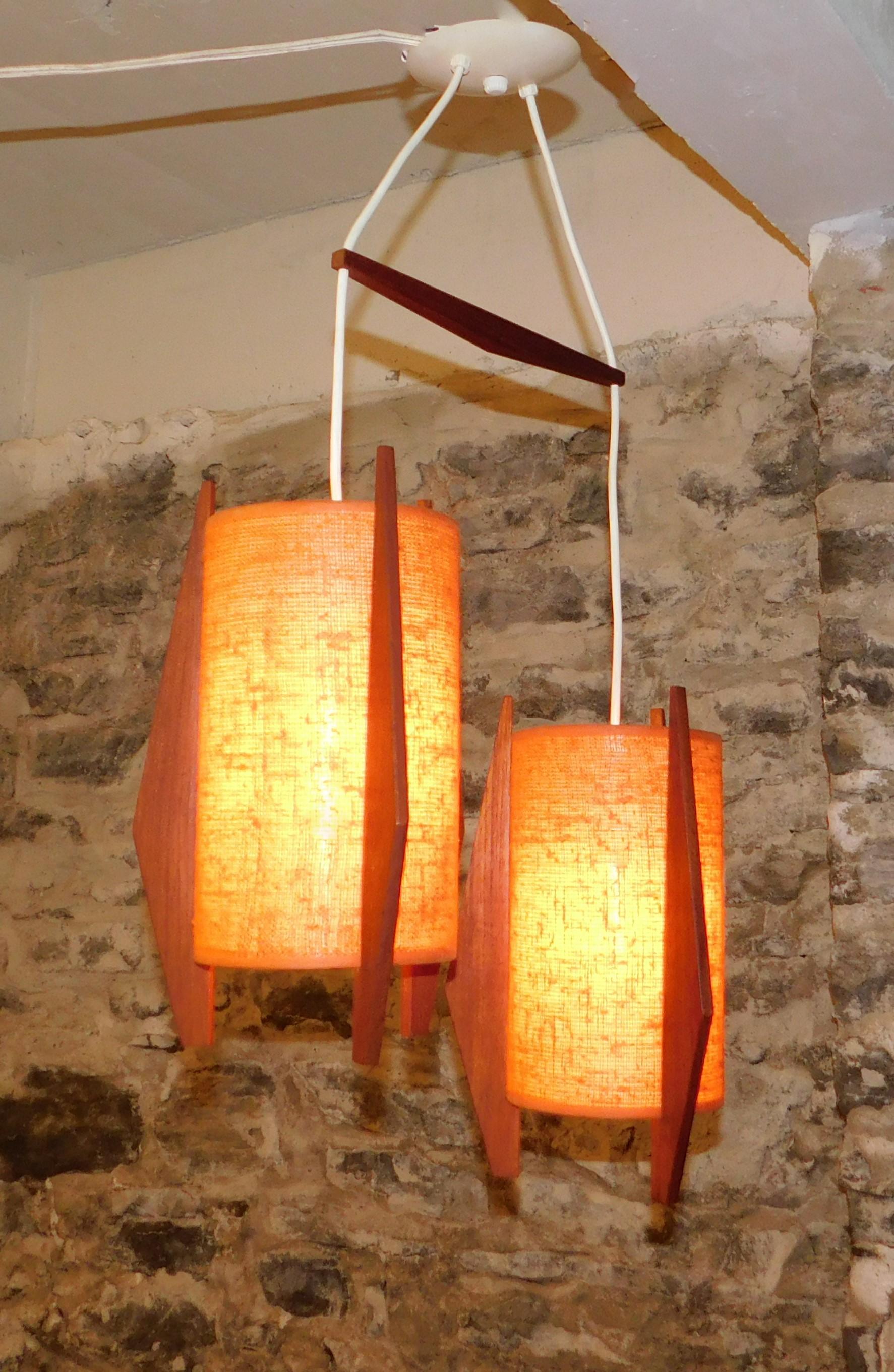 Mid-Century Modern Danish teak and orange fabric hanging double light.
Total height from bottom of light to the top is 31 inches. Each light is 7 inches round X 13.5 inches high.