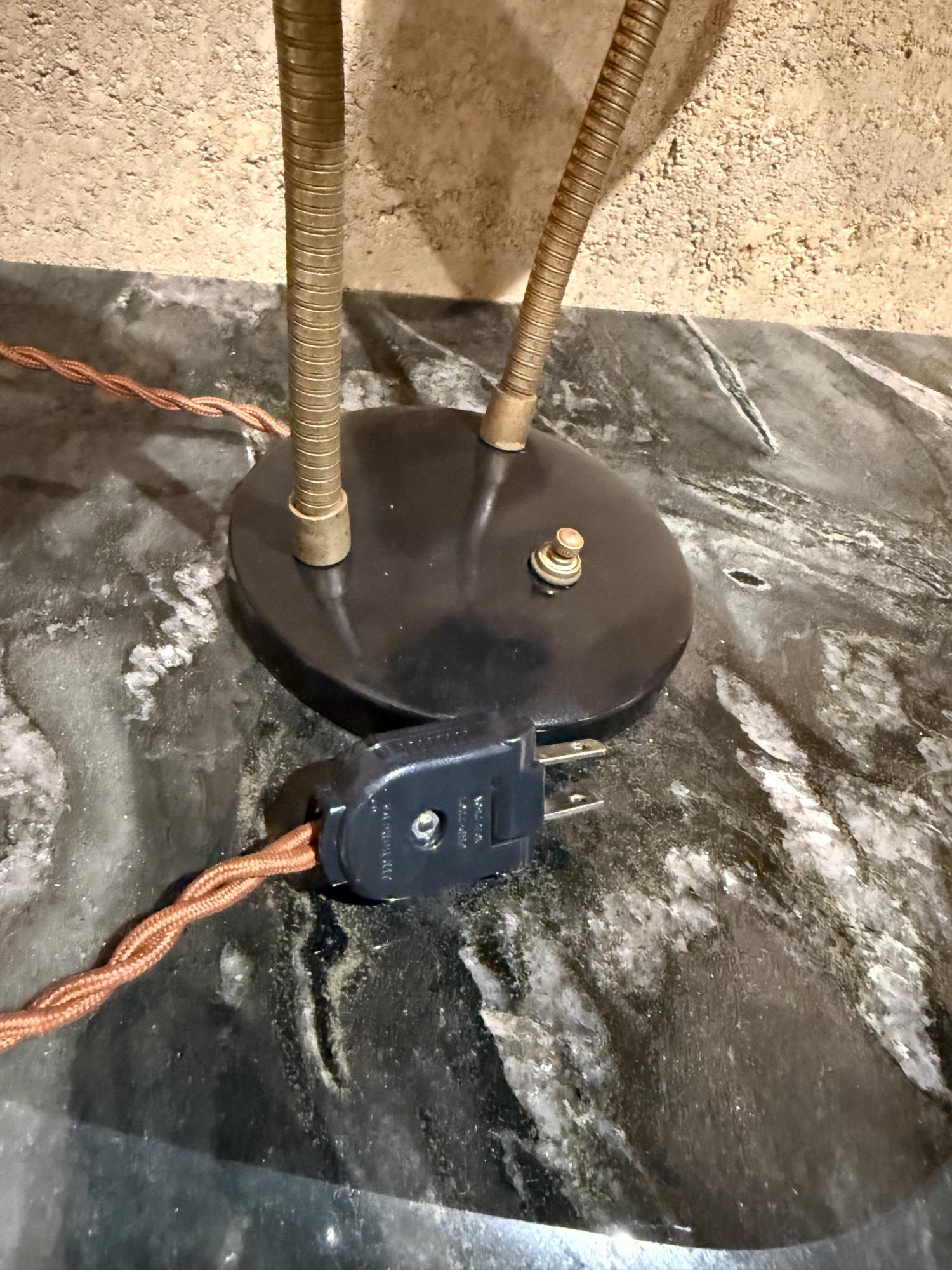 For your consideration, a mid-century modern double-headed desk lamp in the style of Gerald Thurston for Lightolier, featuring black metal shades, a black base, and brass gooseneck arms. Unmarked. 

Dimensions: 11