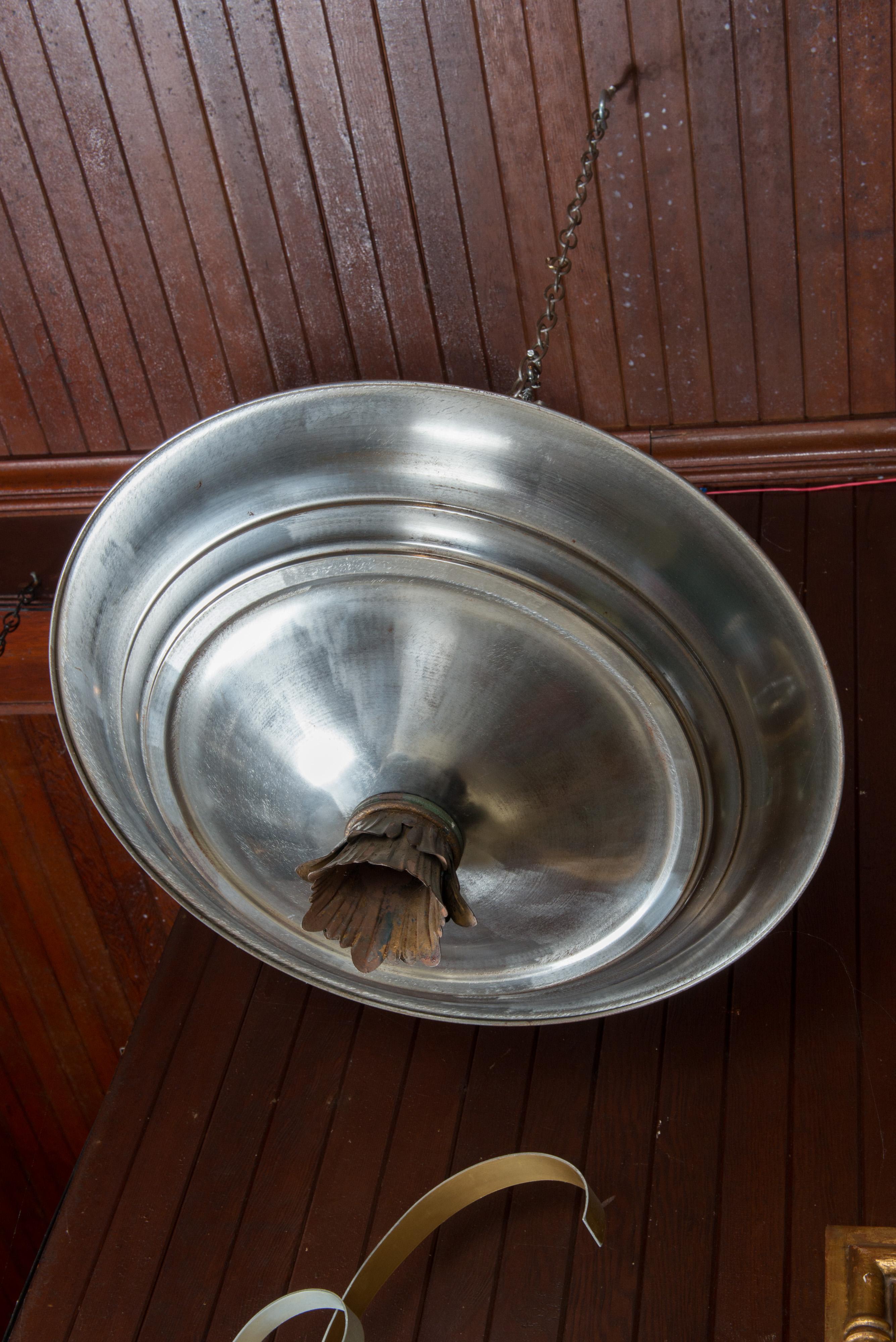 Mid-Century Modern brass and silver toned metal double saucer pendant chandelier. 
Lower saucer accommodates six standard socket chandelier bulbs. Upper saucer accommodates
three standard socket bulbs.