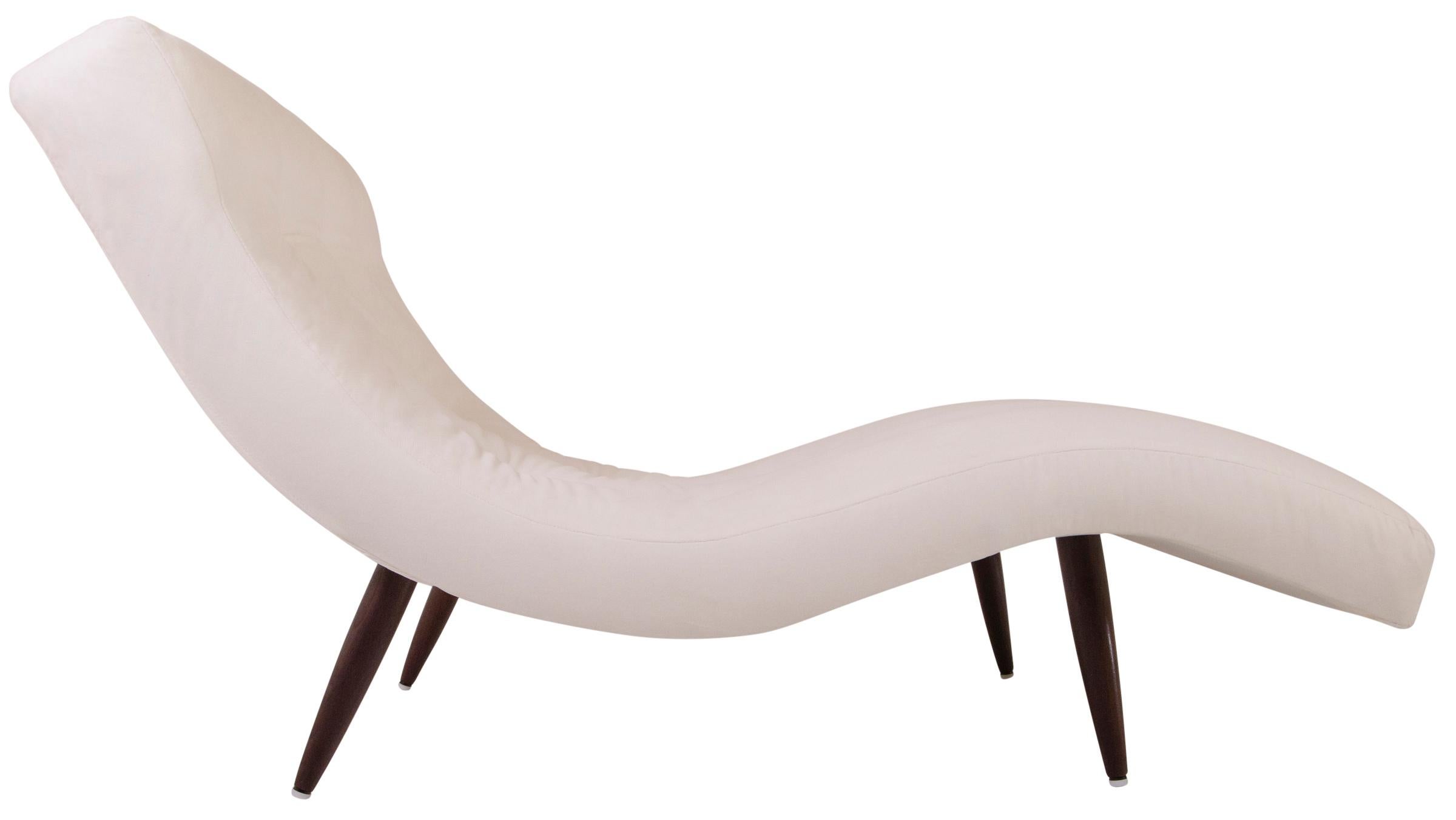Iconic midcentury design by one of the truly inventive creators, Adrian Pearsall. Delicate yet strong tapered wood legs support a wavy chaise that is generously proportioned to hold two. Meticulously tailored and custom upholstered in a rich Ivory