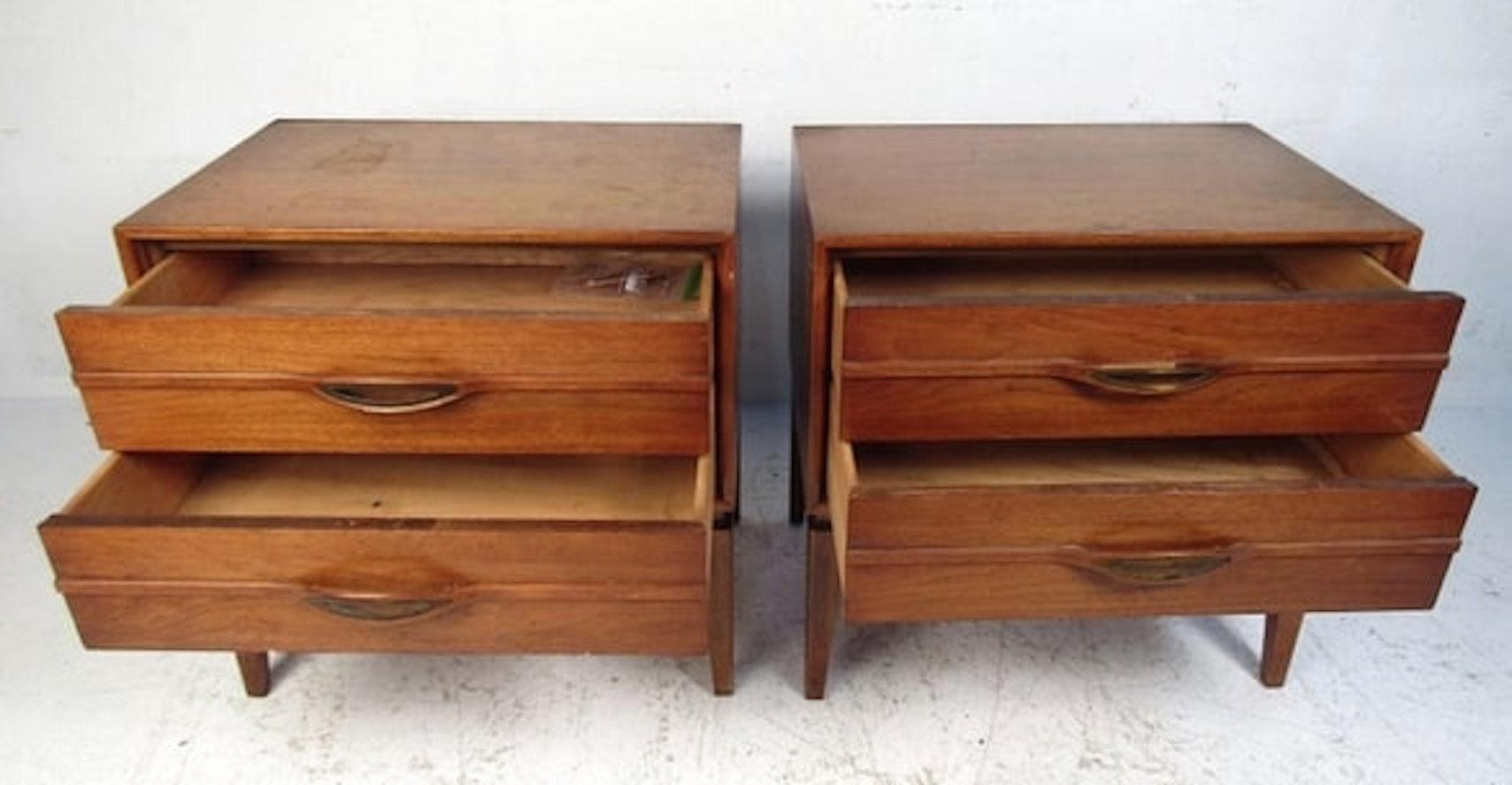 Mid-Century Modern walnut nightstands with sculpted wood handles. Two drawers with brass trim handles.
Please confirm location NY of NJ.