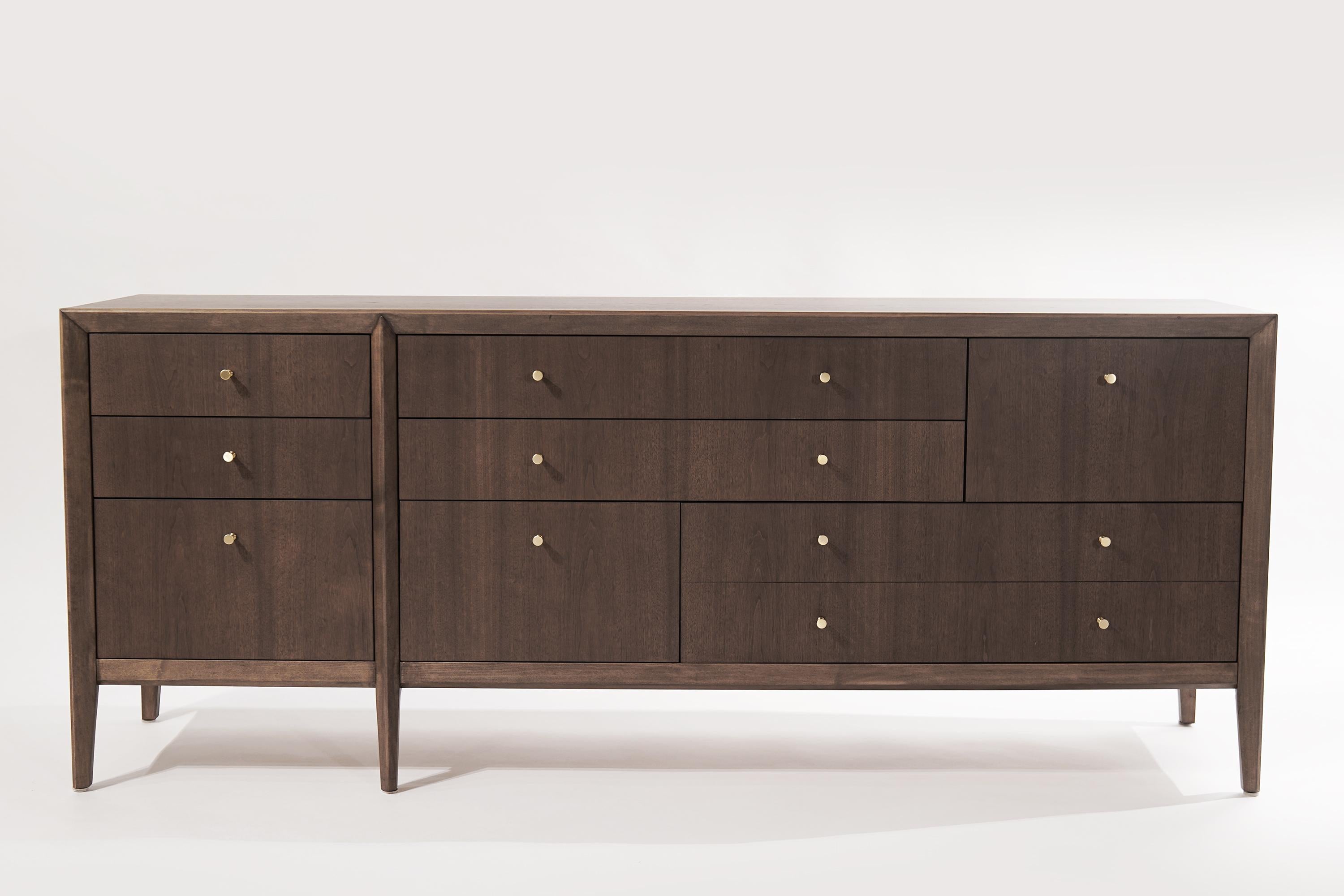 A walnut dresser or sideboard designed by Kipp Stewart, circa 1950-1959.

Featuring eight drawers in an asymmetrical design, providing ample storage space. Completely restored and refinished in an organic matte scratch/water-resistant