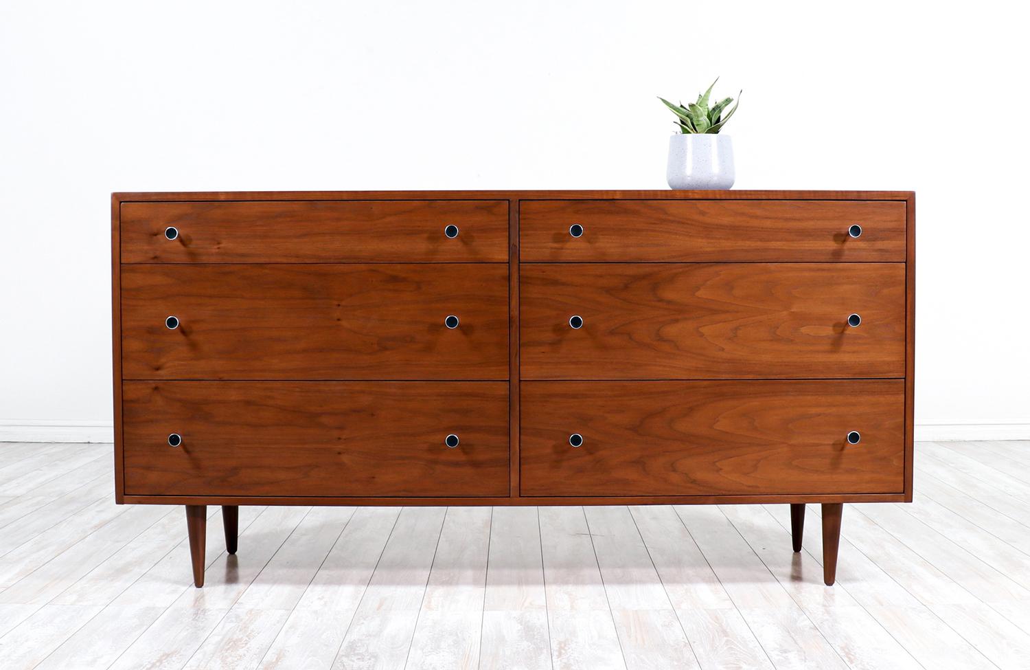 Mid-century modern dresser designed by Kipp Stewart and Stewart MacDougall for Glenn of California in the United States circa 1950s. Newly refinished by our expert craftsmen, this spectacular six-drawer dresser features dovetailed construction and a
