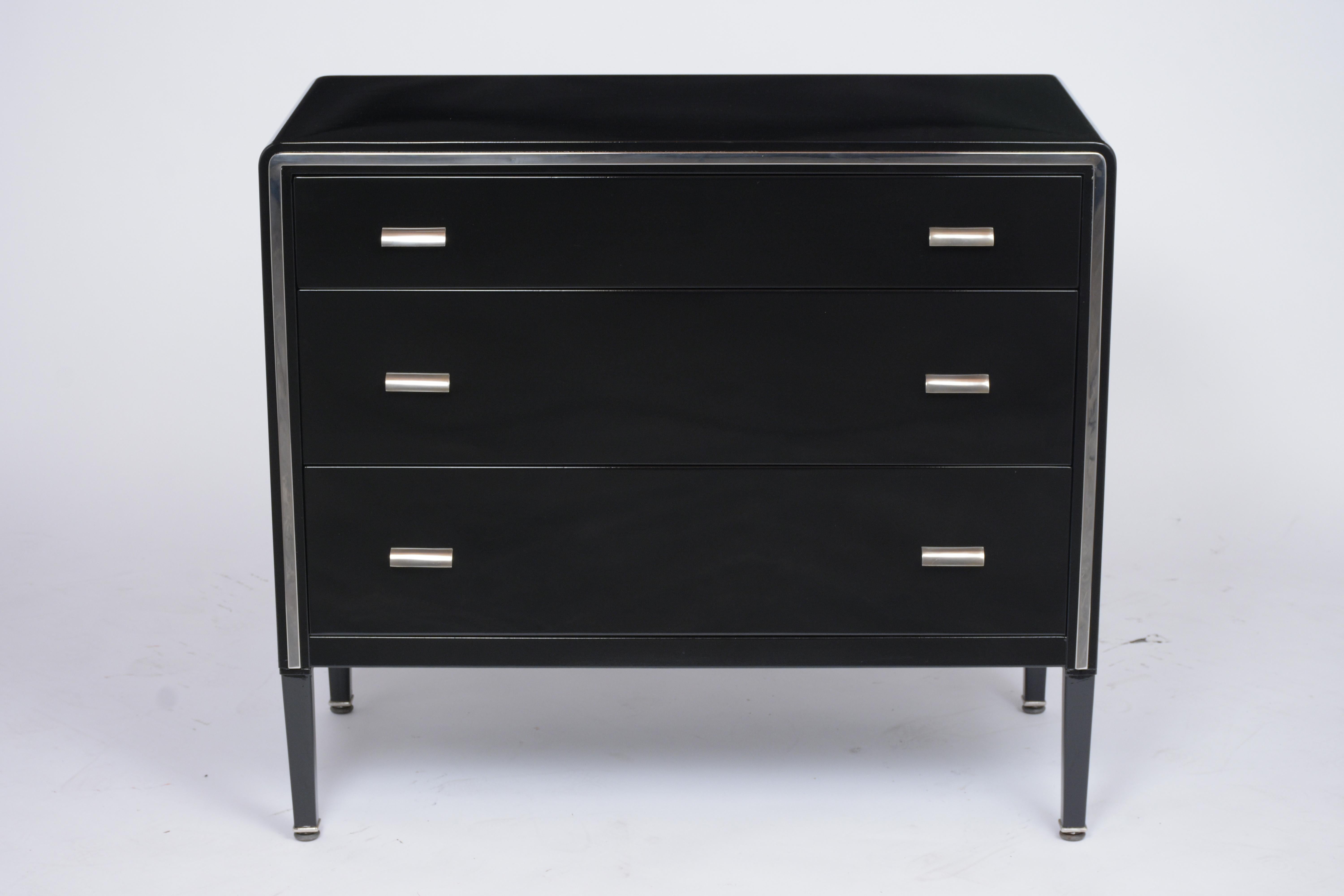This modern chest of drawers by Simmons Company has been newly restored, made out metal, and is in good condition. This piece features a black color lacquered finish, flat chrome molding along the front, and three drawers with two chrome handles
