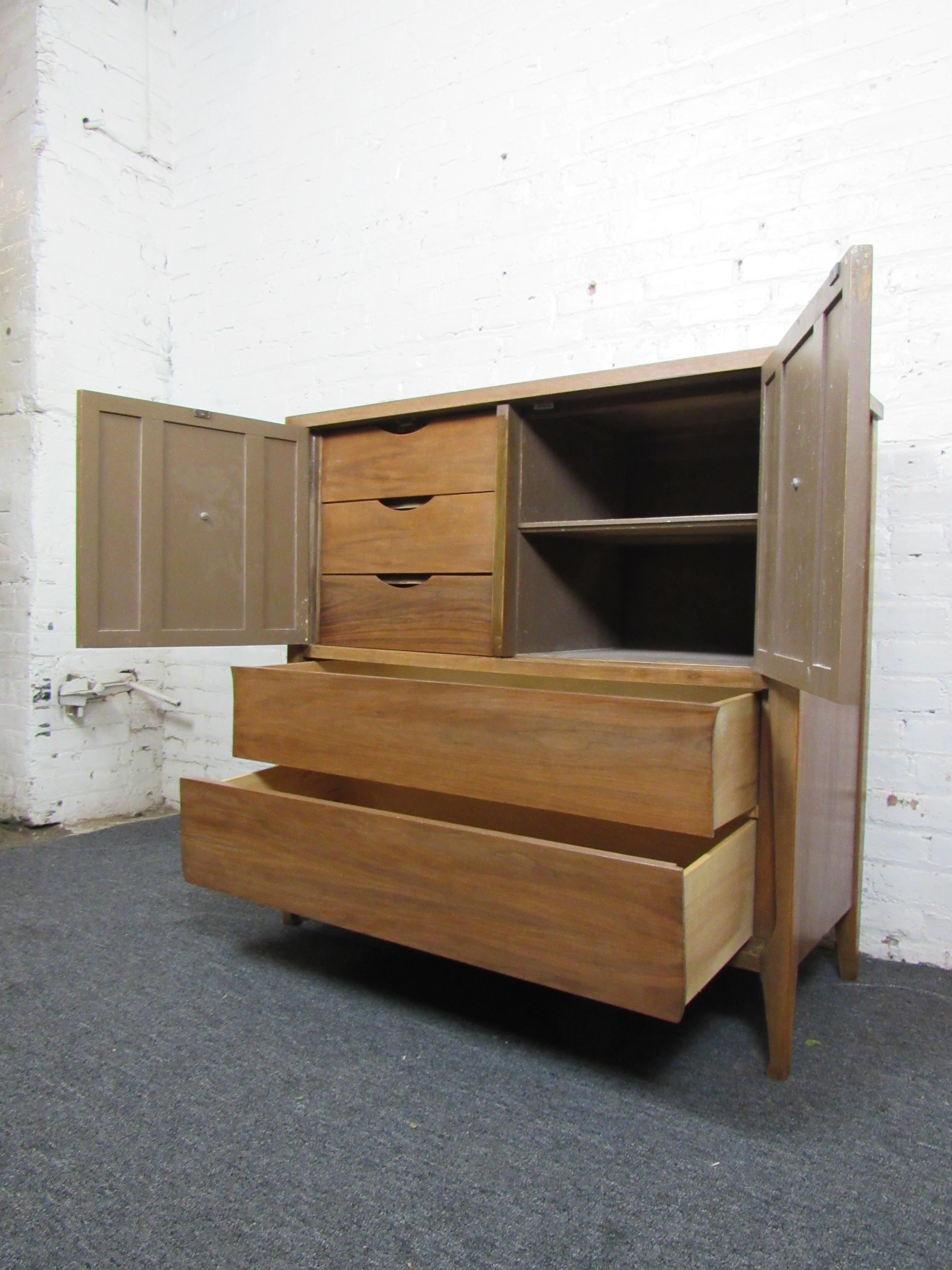 Nice mid-century dresser with wicker accent panels. Top doors open to reveal shelving and five slide-out drawers for plenty of storage options. Please confirm item location with seller (NY/NJ).