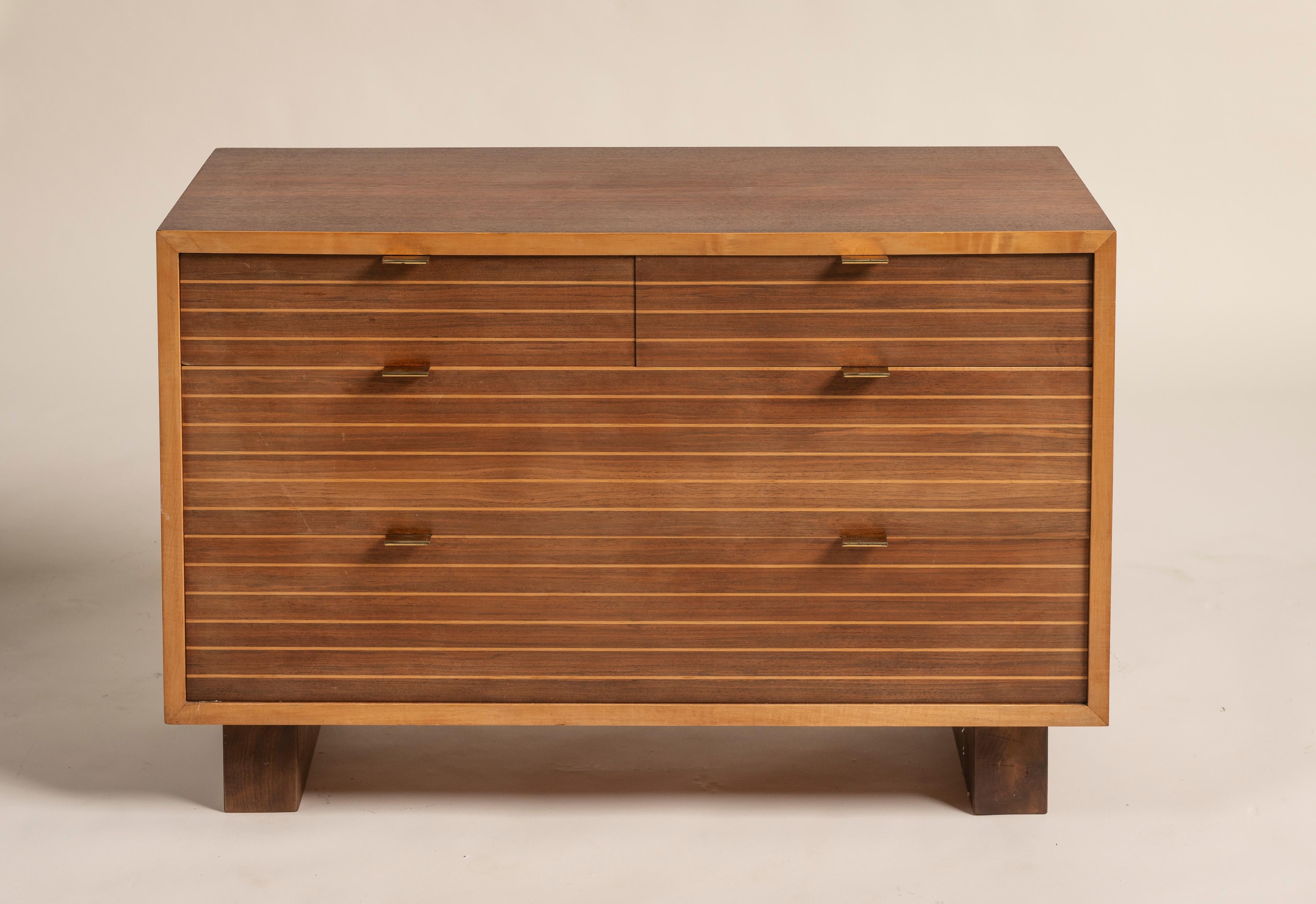 This sleek Scandinavian-inspired mid-century modern dresser will elevate your space.  Its versatile size fits perfectly in bedrooms, living rooms, or entryways. Crafted from warm-toned wood, it features sleek horizontal grooves, brass-finished