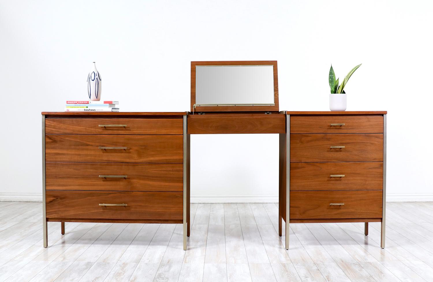 Introducing the Mid-Century Modern Dresser Set with Vanity by Paul McCobb for Calvin Furniture, a vintage gem that epitomizes enduring charm. Crafted in the 1950s, this set embodies the Mid-Century Modern style with its clean lines, minimalist