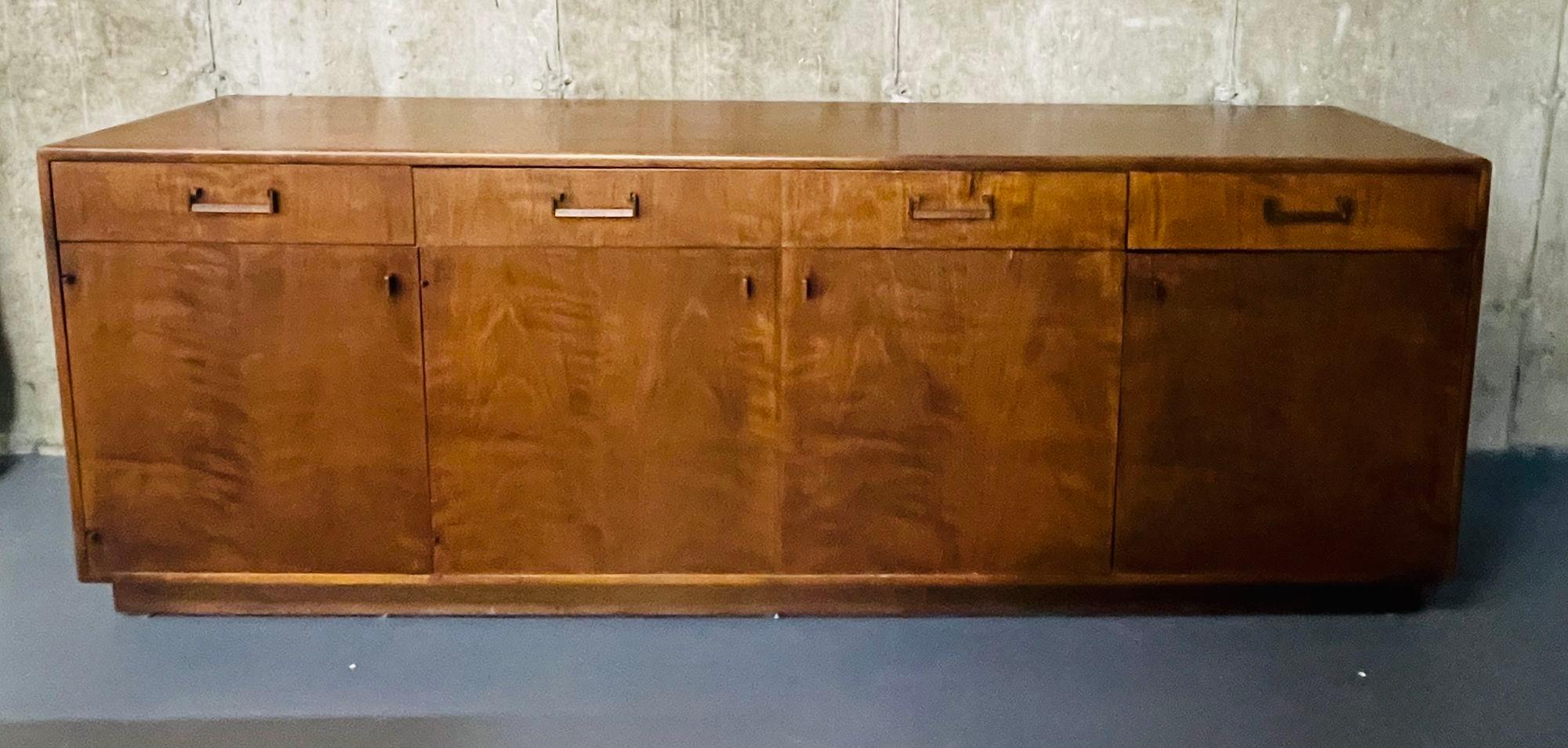 Mid-Century Modern Dresser / Sideboard, Brass, American Designer
Walnut Mid Cent Dresser or Chest having four drawers above four doors leading to large open interiors. the whole having rectangular industrial style drawer pulls. 
One small veneer