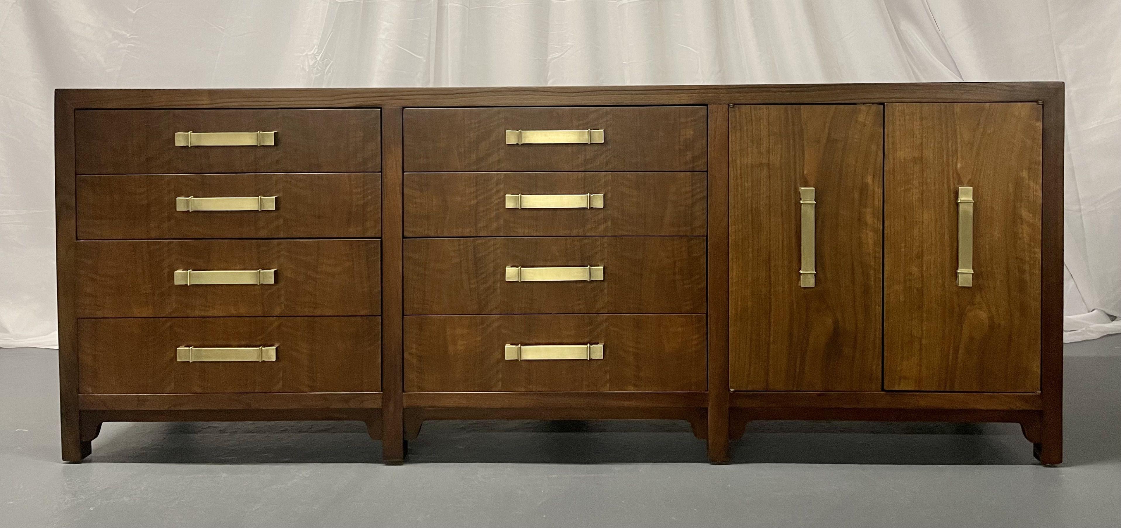 Mid-Century Modern dresser/sideboard, American Designer, walnut, brass accents.

Mid-Century storage cabinet made of solid walnut having newly cleaned brass drawer pulls. This piece is not only beautiful, but also functional, fit with 10 total