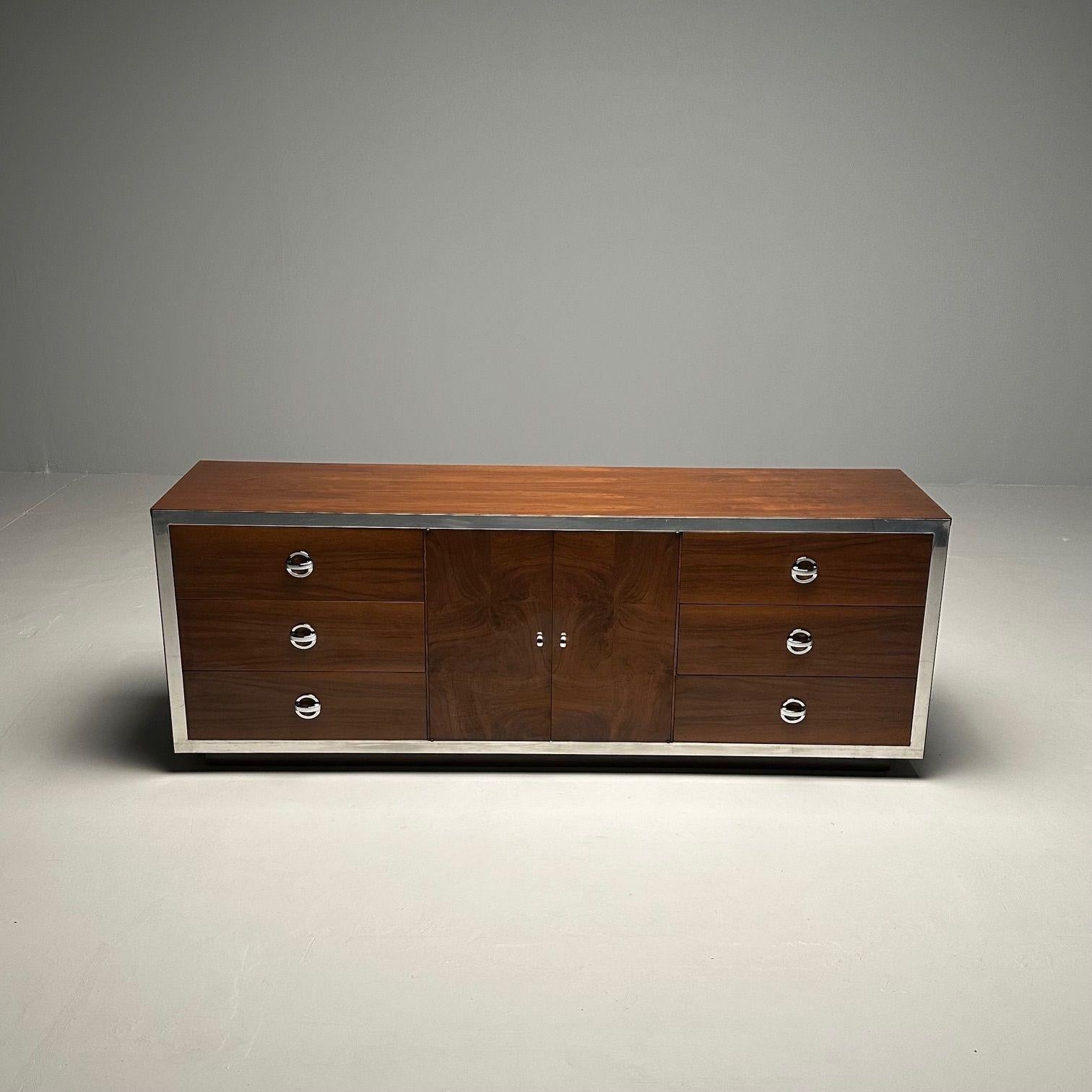 Mid-Century Modern Dresser / Sideboard by Milo Baughman, Chrome, Walnut

This fine rosewood style veneer fronts having chrome pulls with chrome framed borders. Each having a fitted interior. Available as a compatible pair as well as with two