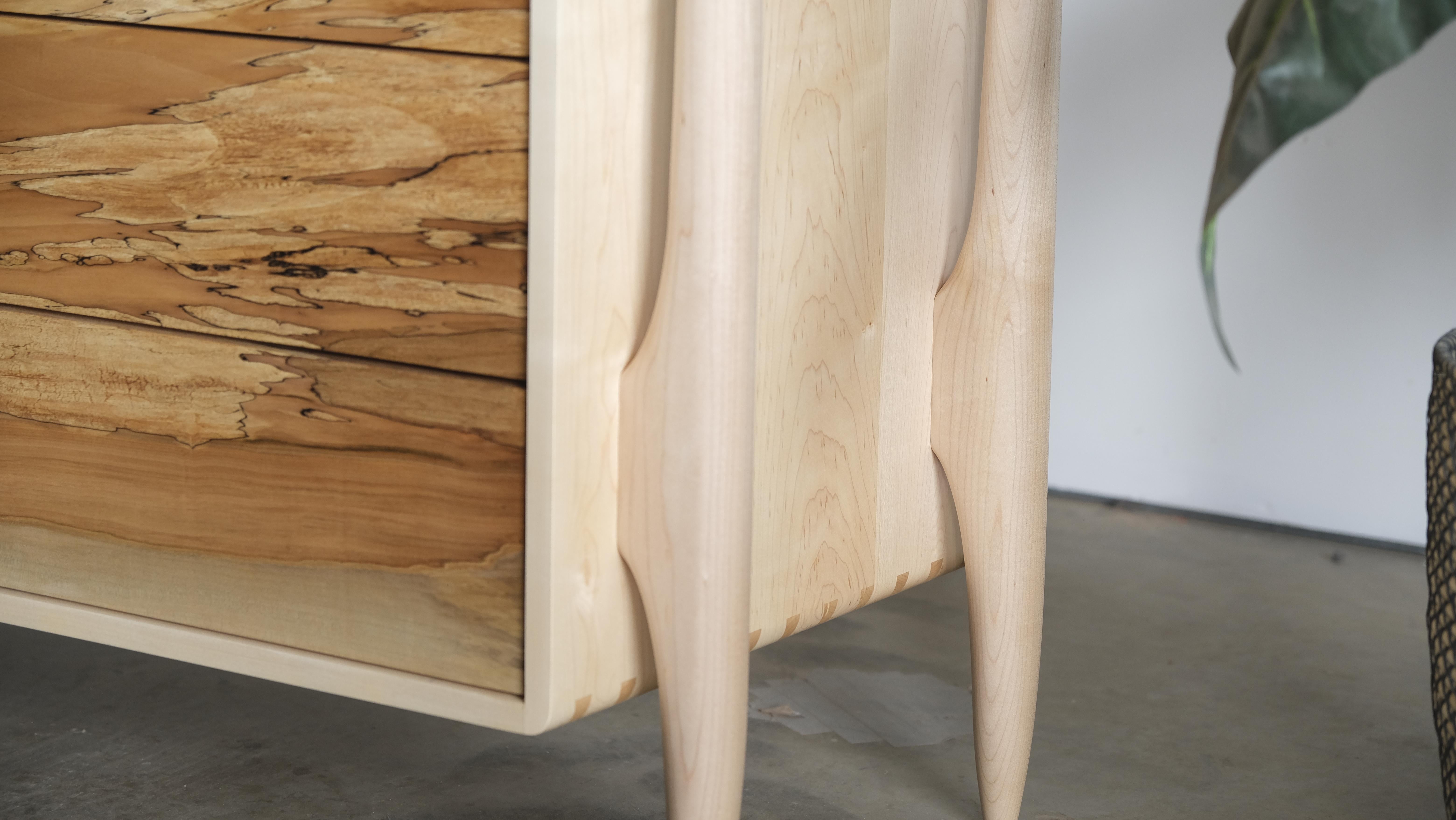 This dresser is made from all solid wood, including the drawers and built using several forms of exposed joinery and hand shaping. I would put this piece closer to a form of art than pure function. The exposed dovetail case, exposed through tenons