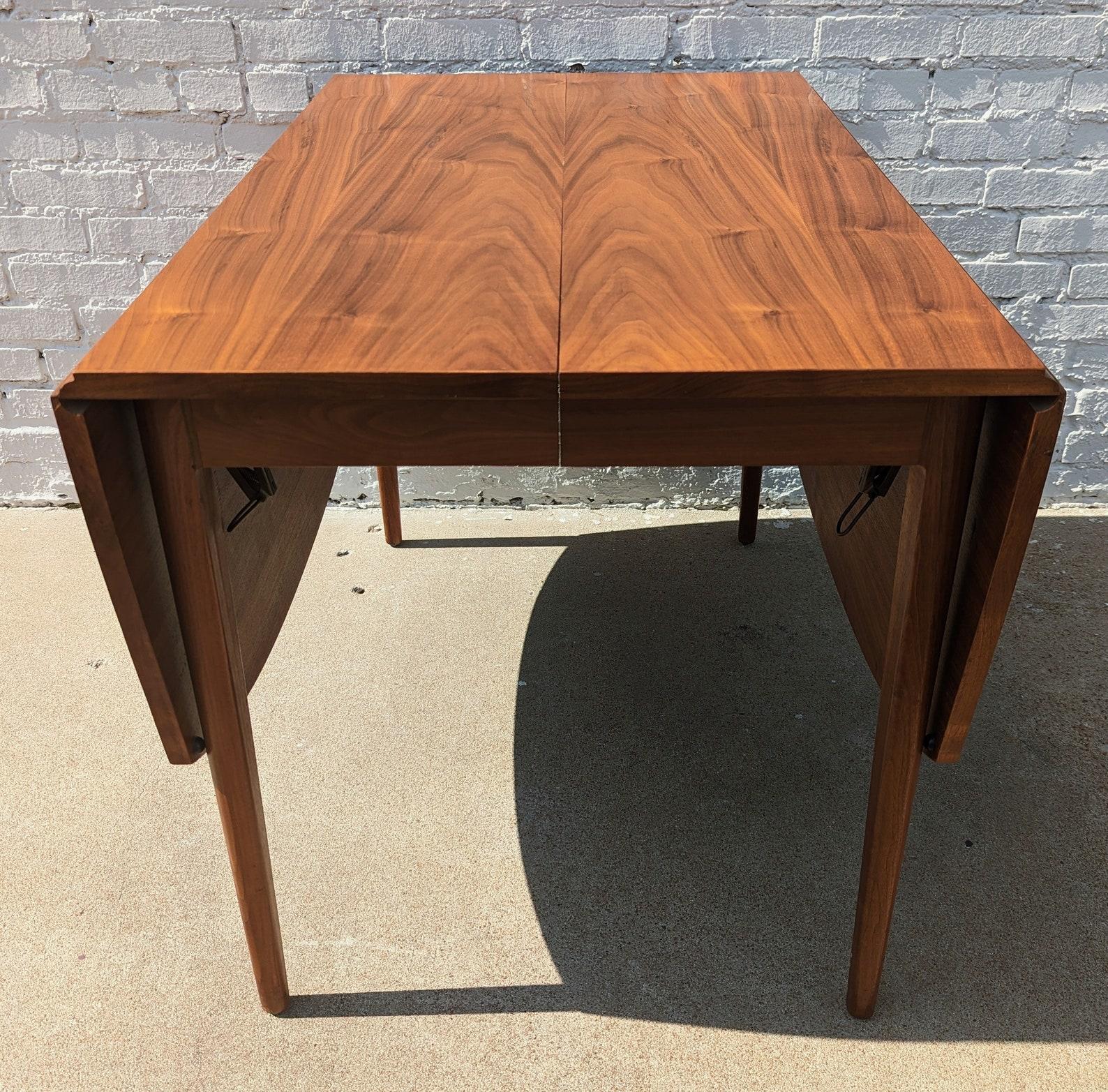 Mid Century Modern Drexel Declaration Dining Table by Kip Stewart

Above average vintage condition and structurally sound. Has some expected slight finish wear and scratching. Has a couple small dings and discolorations on top and edges. Has a
