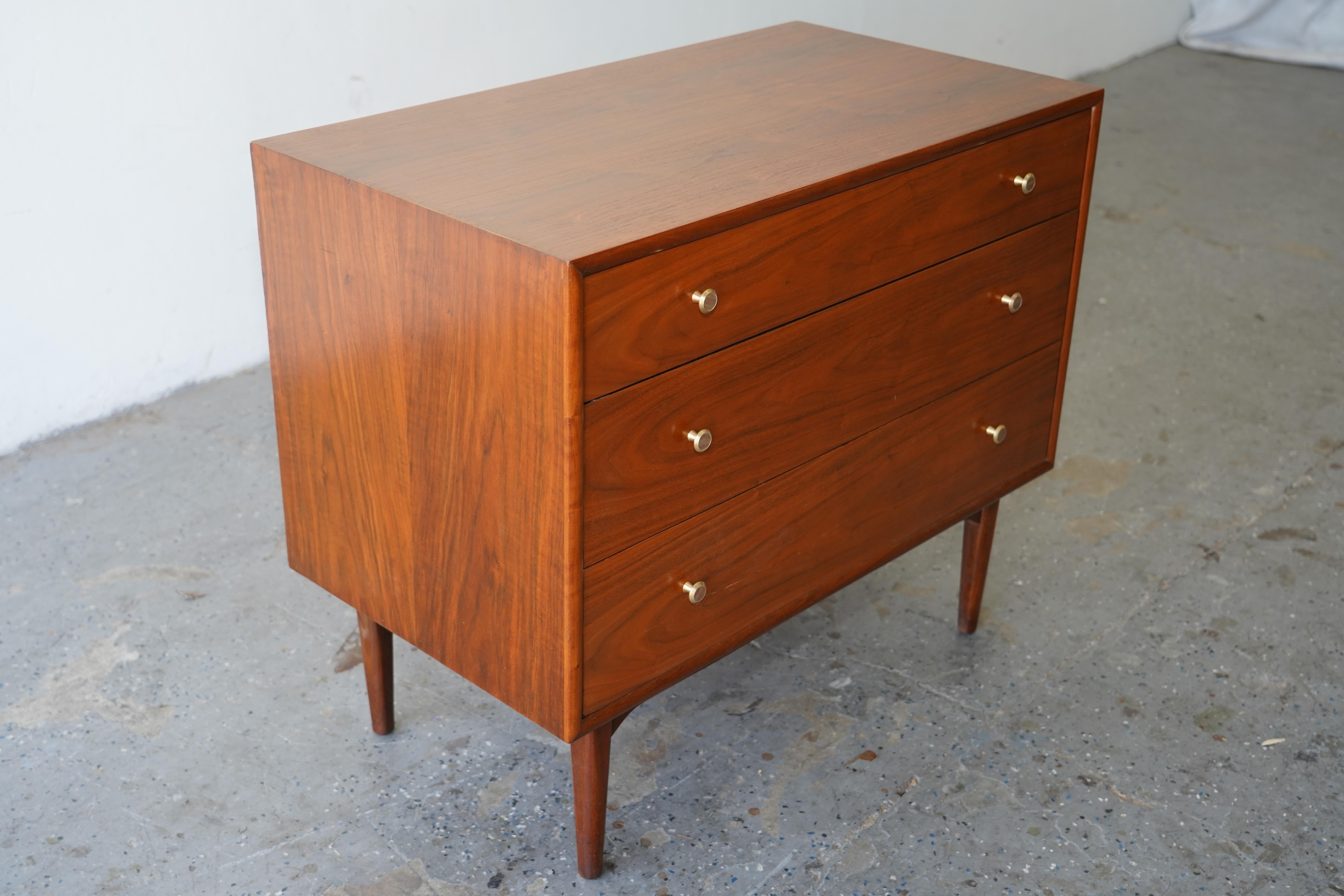 This exquisite Small Dresser is a hallmark of Drexel's premium Declaration line, exemplifying the brand's commitment to exceptional craftsmanship. Designed by the renowned Kipp Stewart and Stewart MacDougall, this piece features a rich, oiled walnut