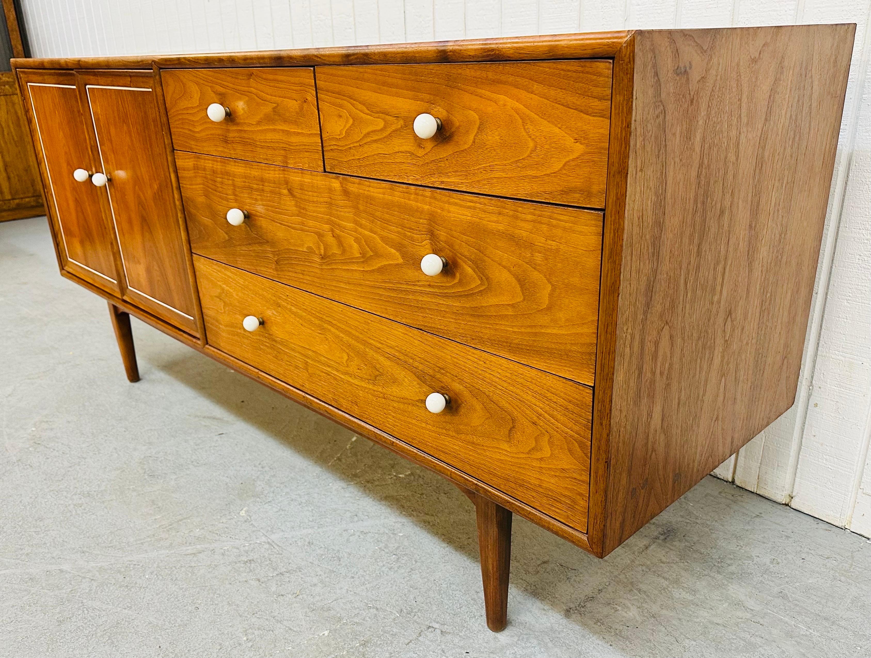 Declaration Walnut 10-Drawer Dresser. Featuring four standard drawers on the right side, two doors that push open to reveal six small hidden drawers, original milk glass knobs, a white pin stripe on each door, and a beautiful walnut finish. This is