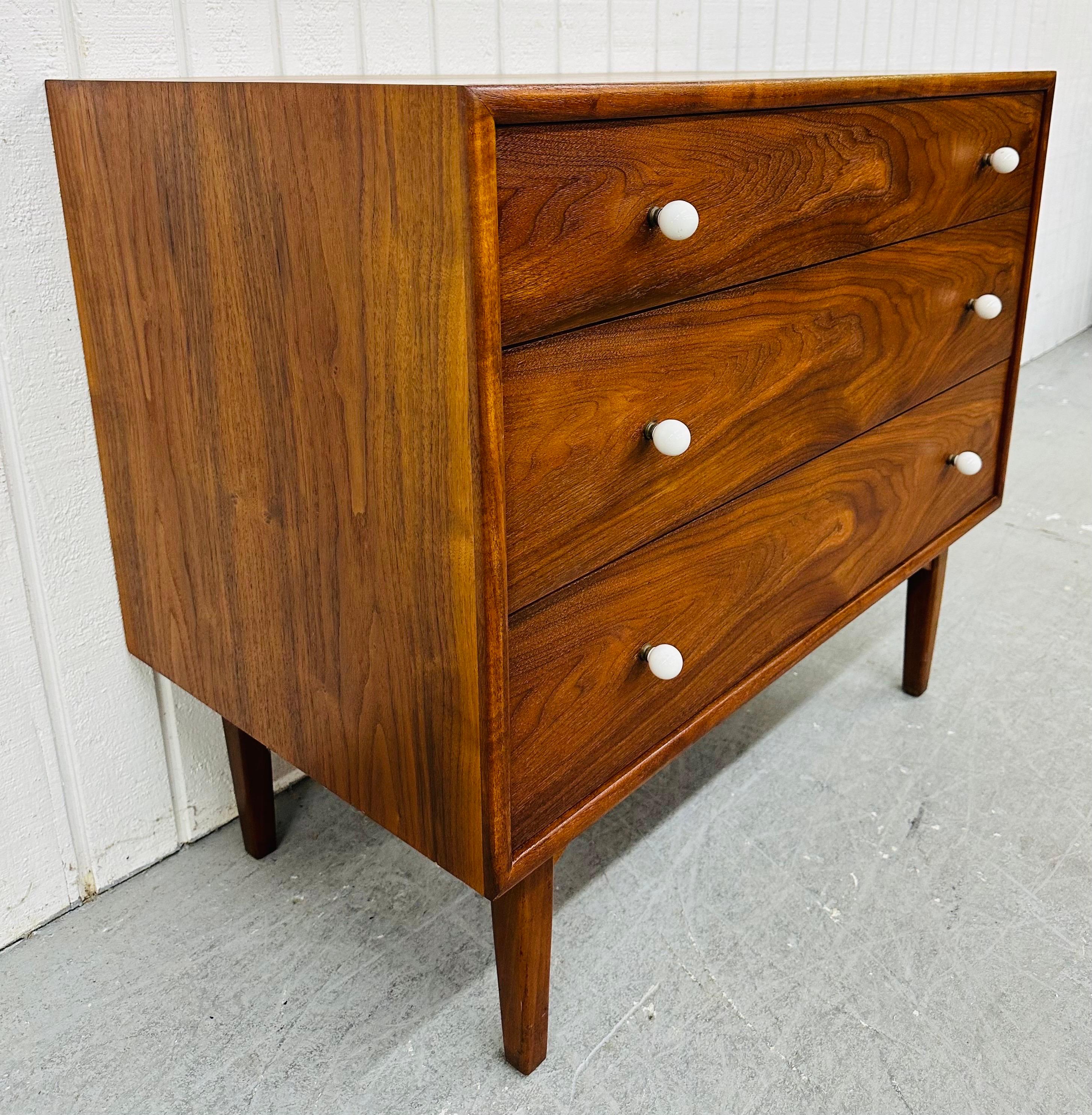This listing is for a Mid-Century Modern Drexel Declaration Walnut Bachelor Chest. Featuring a straight line design, three drawers for storage, original white milk glass hardware, modern legs, and a beautiful walnut finish. This is an exceptional