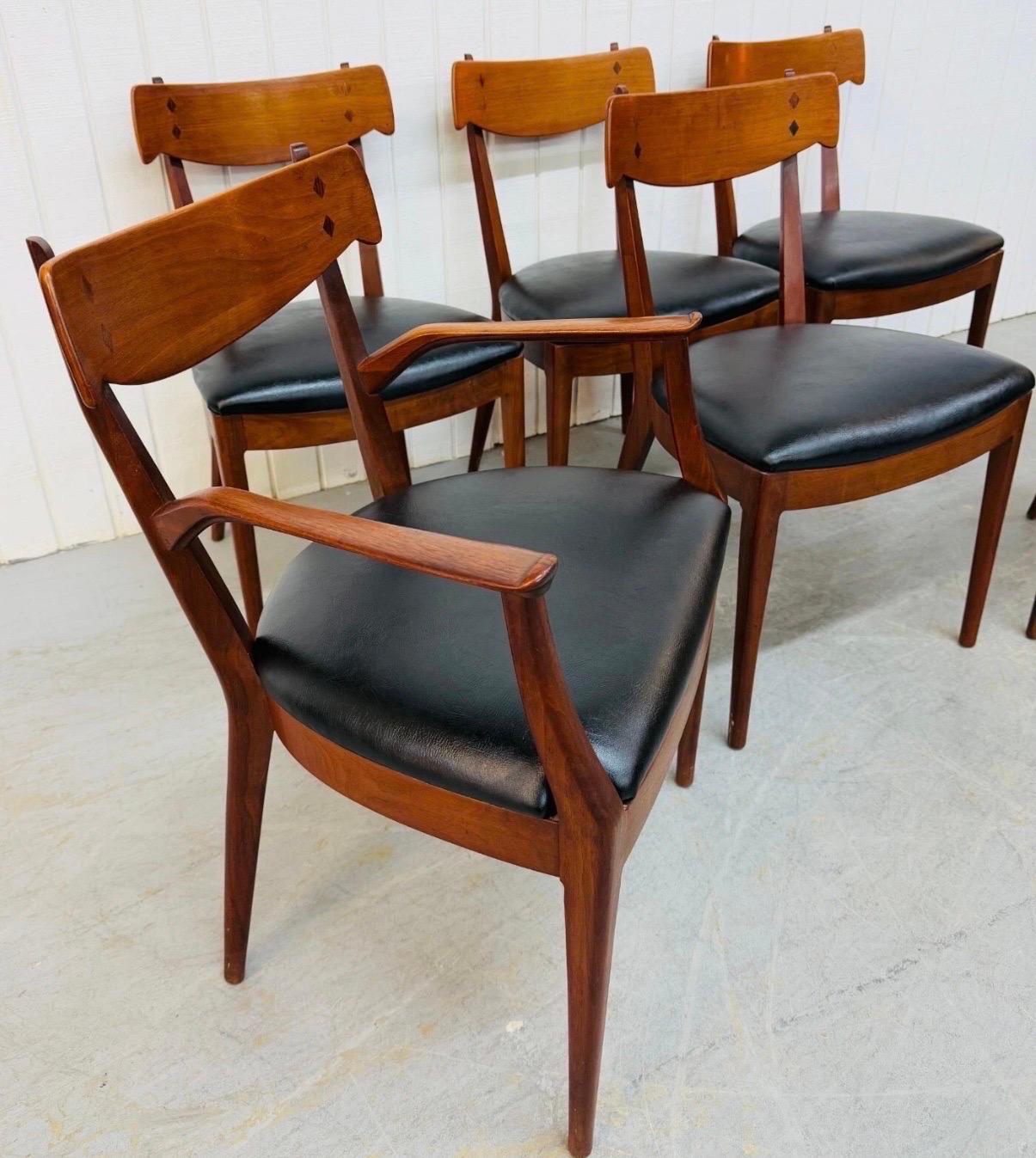 This listing is for a set of six Mid-Century Modern Drexel Declaration Walnut Dining Chairs. Featuring a Kipp Stewart design, two arm chairs, four side chairs, wooden backrests with a diamond inlay, modern legs, new black vinyl seats, and a walnut