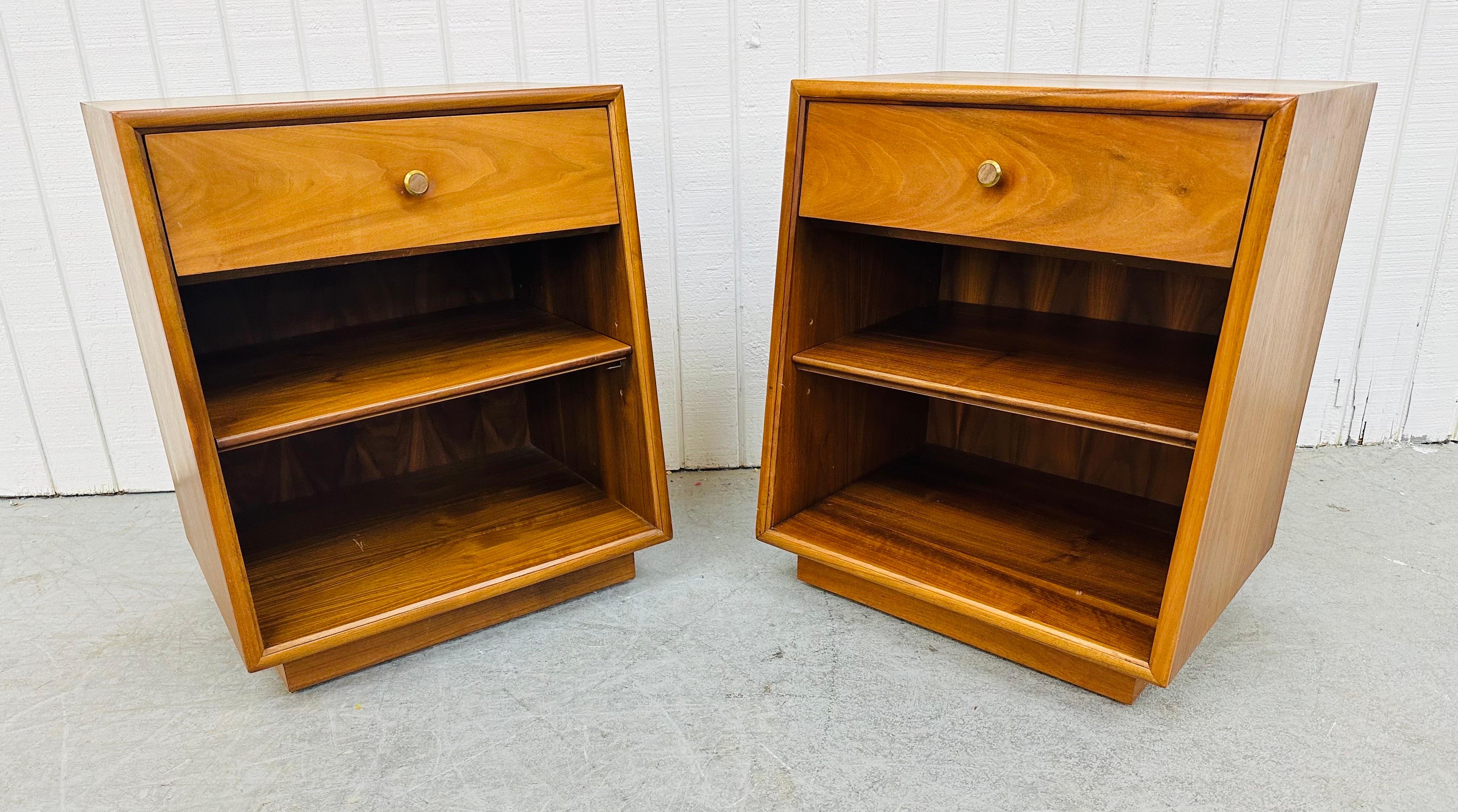 This listing is for a pair of Mid-Century Modern Drexel Declaration Walnut Nightstands. Featuring a straight line design, single drawer with original brass hardware, storage space with a center shelf, and a beautiful walnut finish. This is an