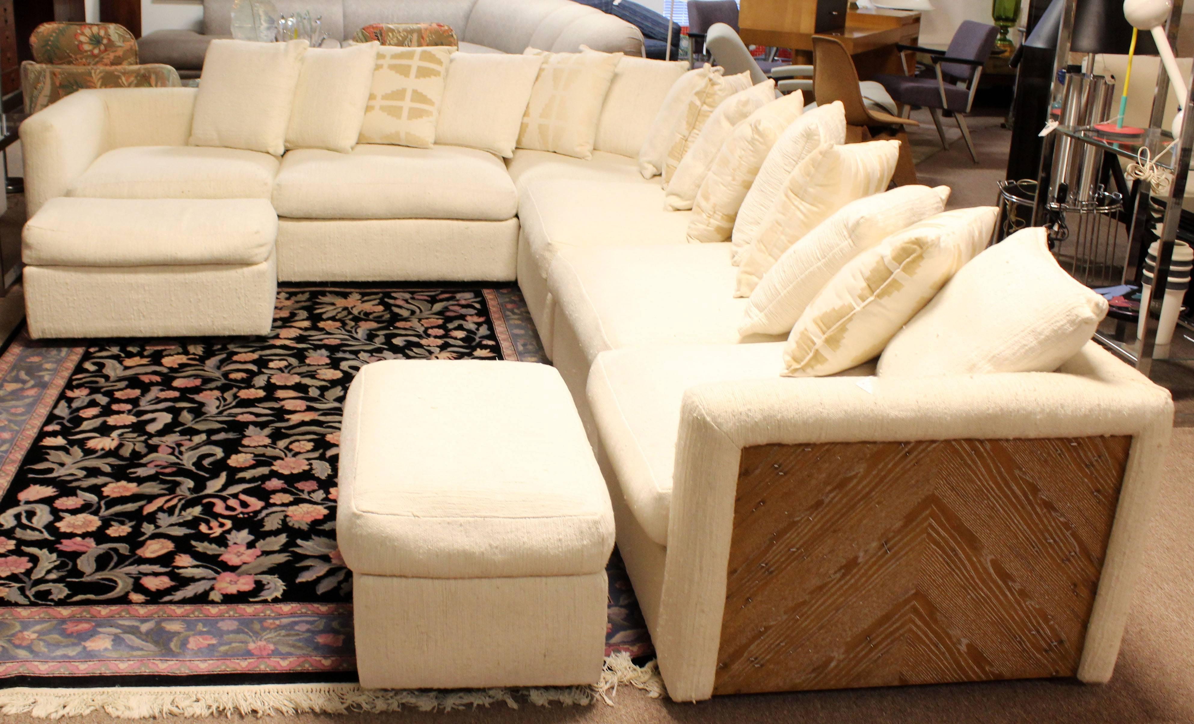 For your consideration is a fabulous, wood encased, six-piece sectional, with two matching ottomans, all on casters, by Drexel Heritage, circa the 1970s. In excellent condition. The dimensions of each piece of the sectional are 34