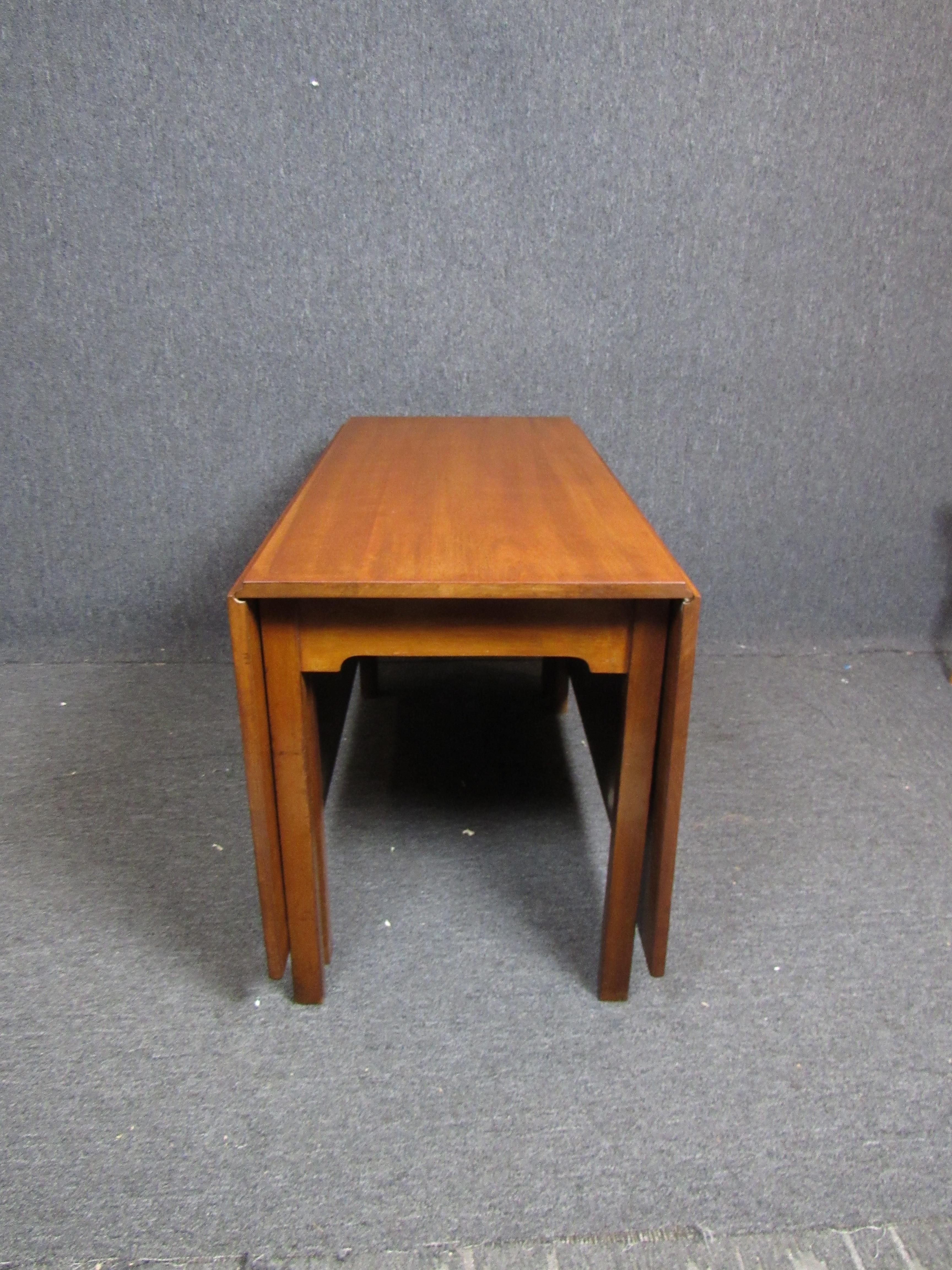 Wonderful mid-century dining table with large drop leaves for ample seating. Measures 67.5