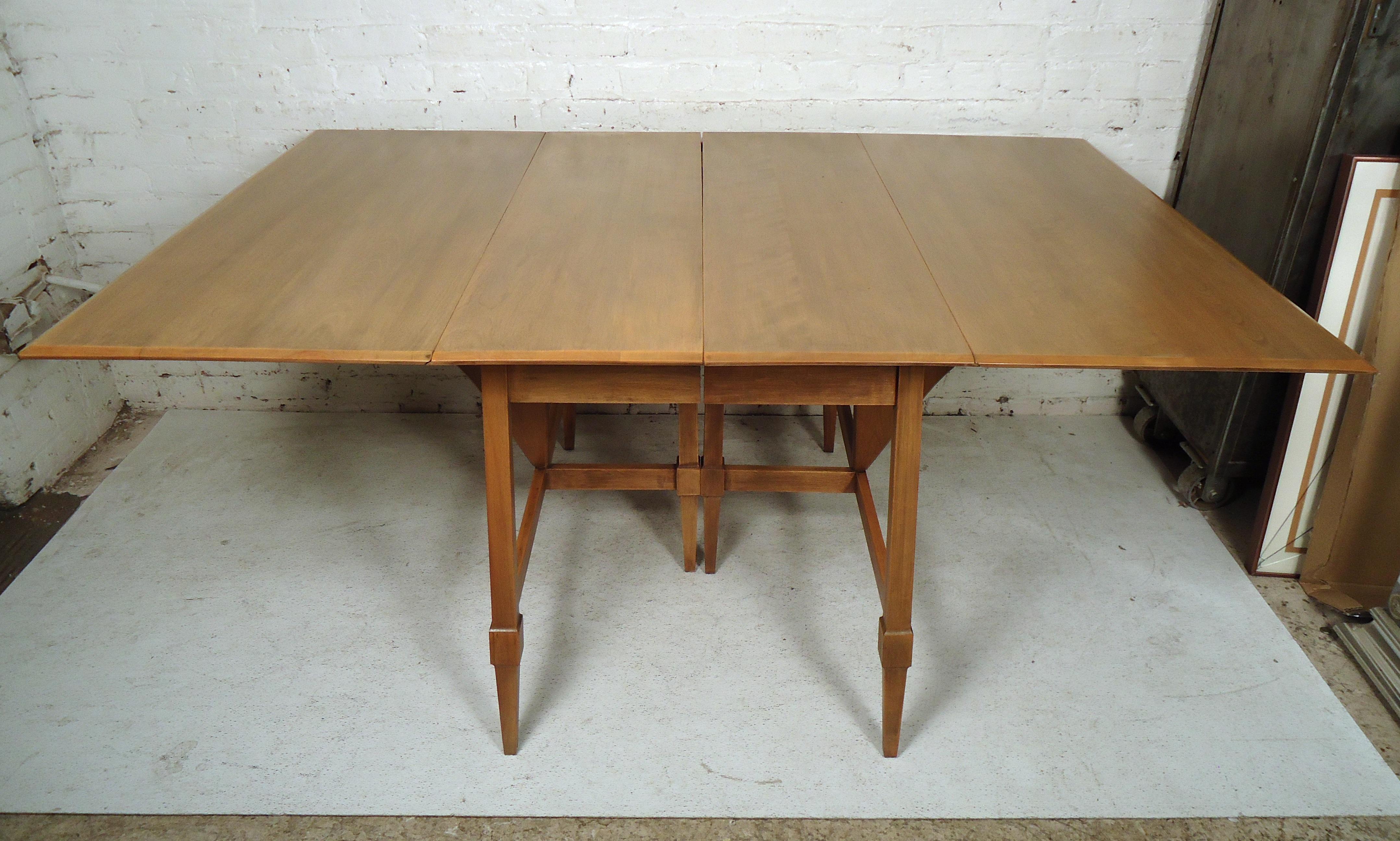 Sleek vintage modern gate leg drop-leaf table opens to 64