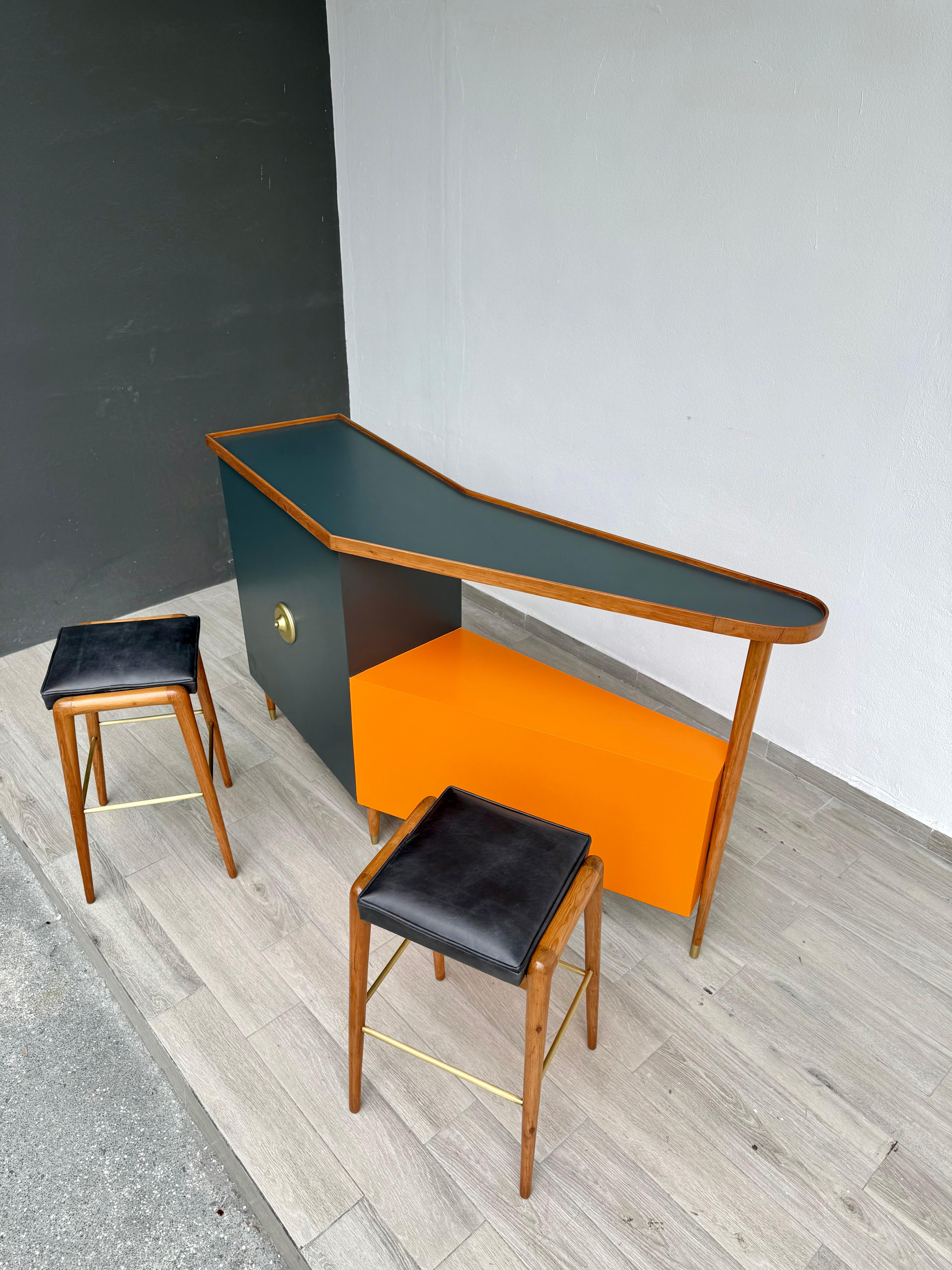 Para tu consideración, barra Moderna de mediados de siglo fabricada a principios de los años 70. Gran parte superior en forma de bumerán. De pino y tableros de MDF pintados con laca (naranja y verde oscuro), con detalles de latón en las patas y los