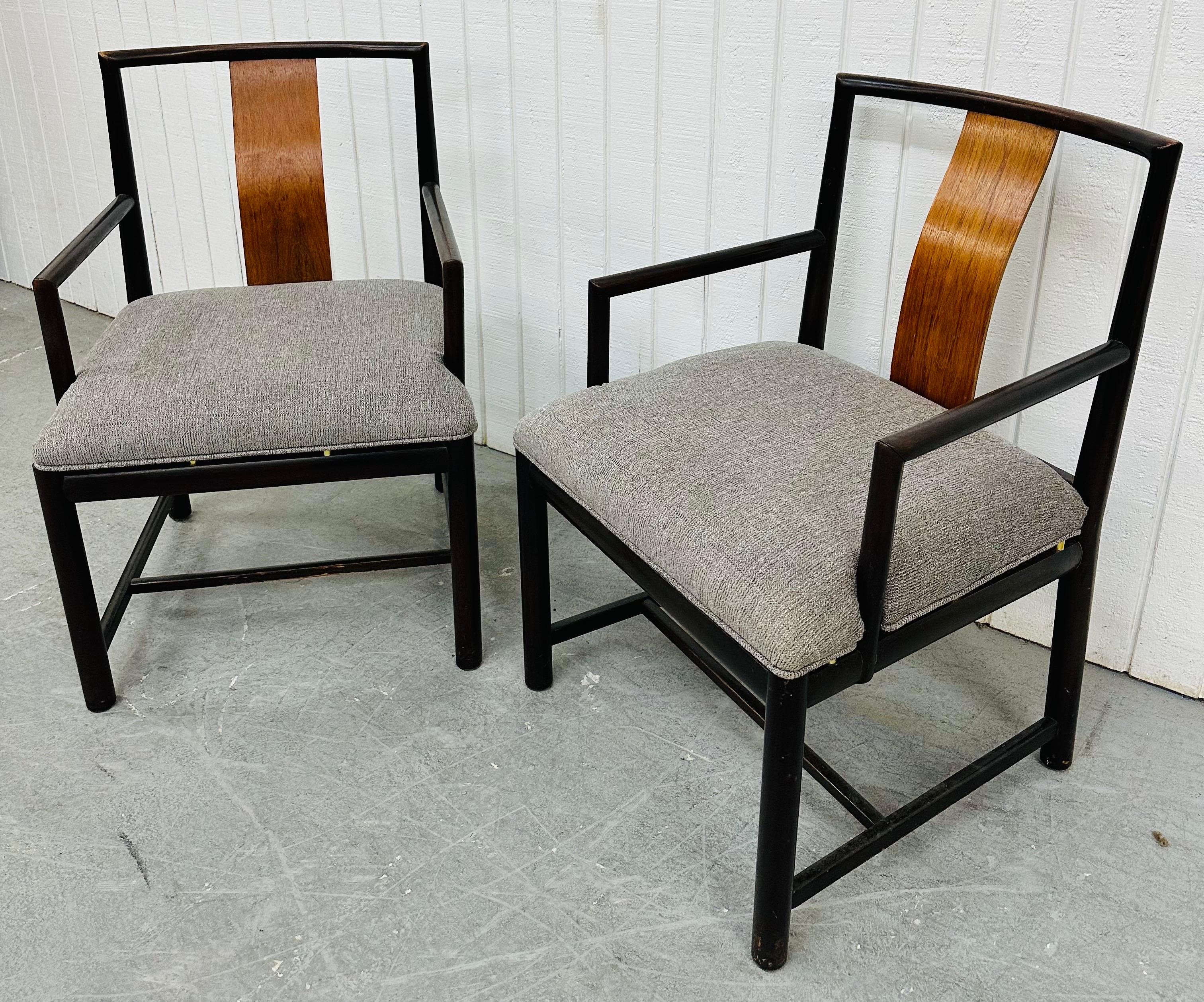 This listing is for a pair of Mid-Century Modern Dunbar Style Arm Chairs. Featuring a straight line design, wooden frames, curved rosewood backrests, and newly upholstered gray seats. This is an exceptional combination of quality and design!