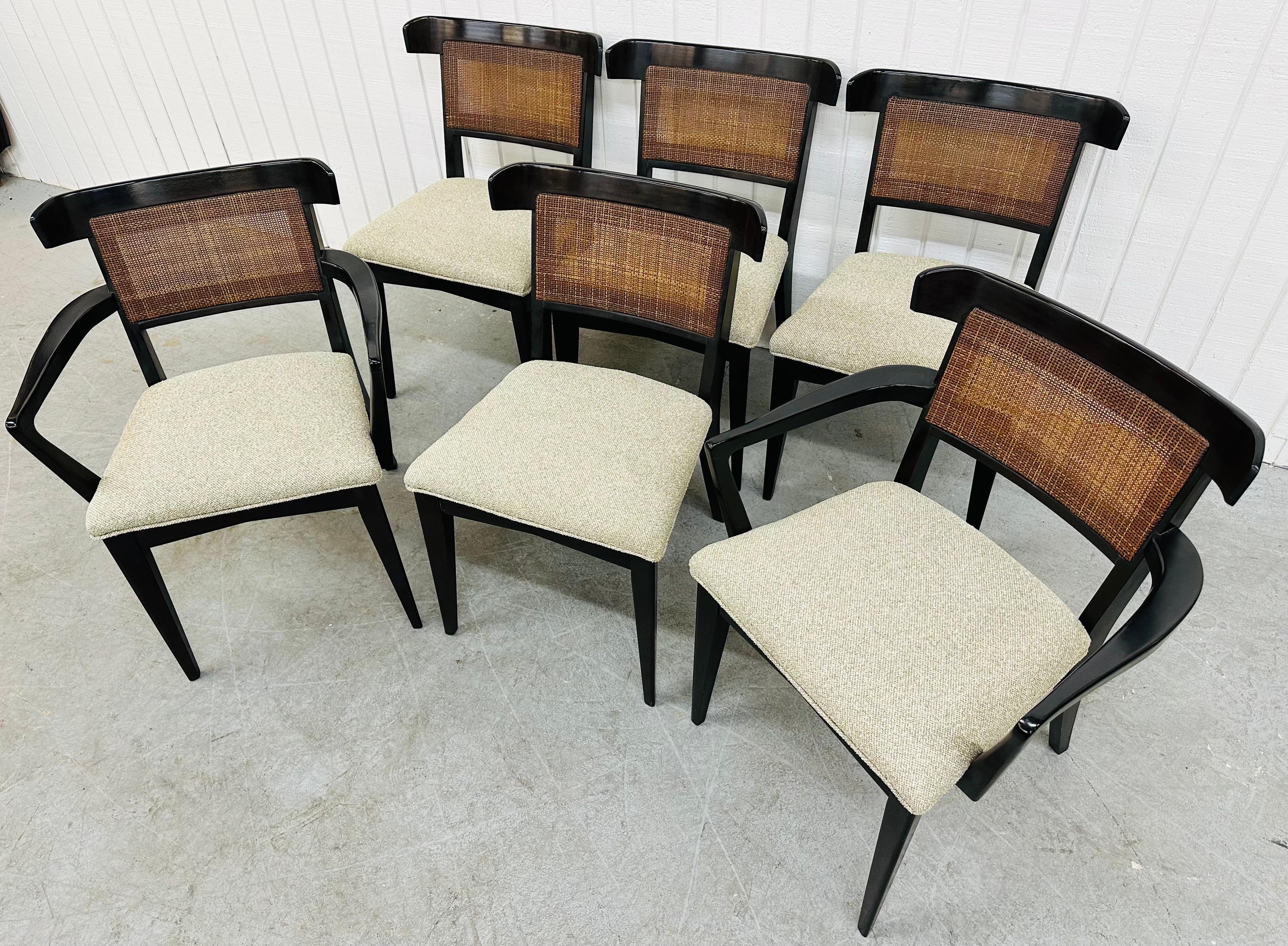 This listing is for a set of six Mid-Century Modern Dunbar Style Dining Chairs. Featuring two arm chairs, four straight chairs, cane backs, black lacquered frames, and newly upholstered gray seats. This is an exceptional combination of quality and