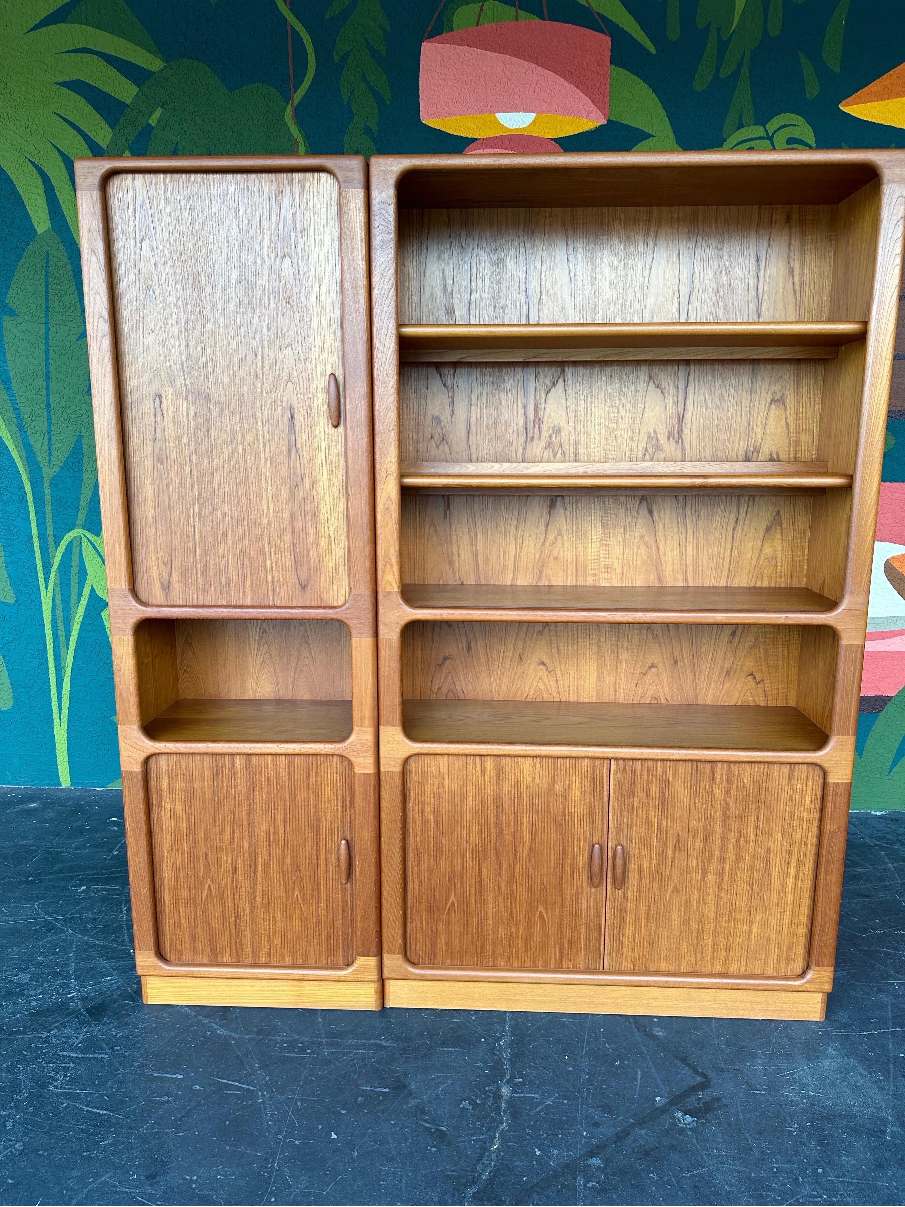 Danish Mid Century two piece free standing wall unit c.1970’s by Dyrlund. Great pieces for display cabinets, bookcases, or additional storage cabinets for any room. Can be used separately or together, both pieces are free standing and finished on