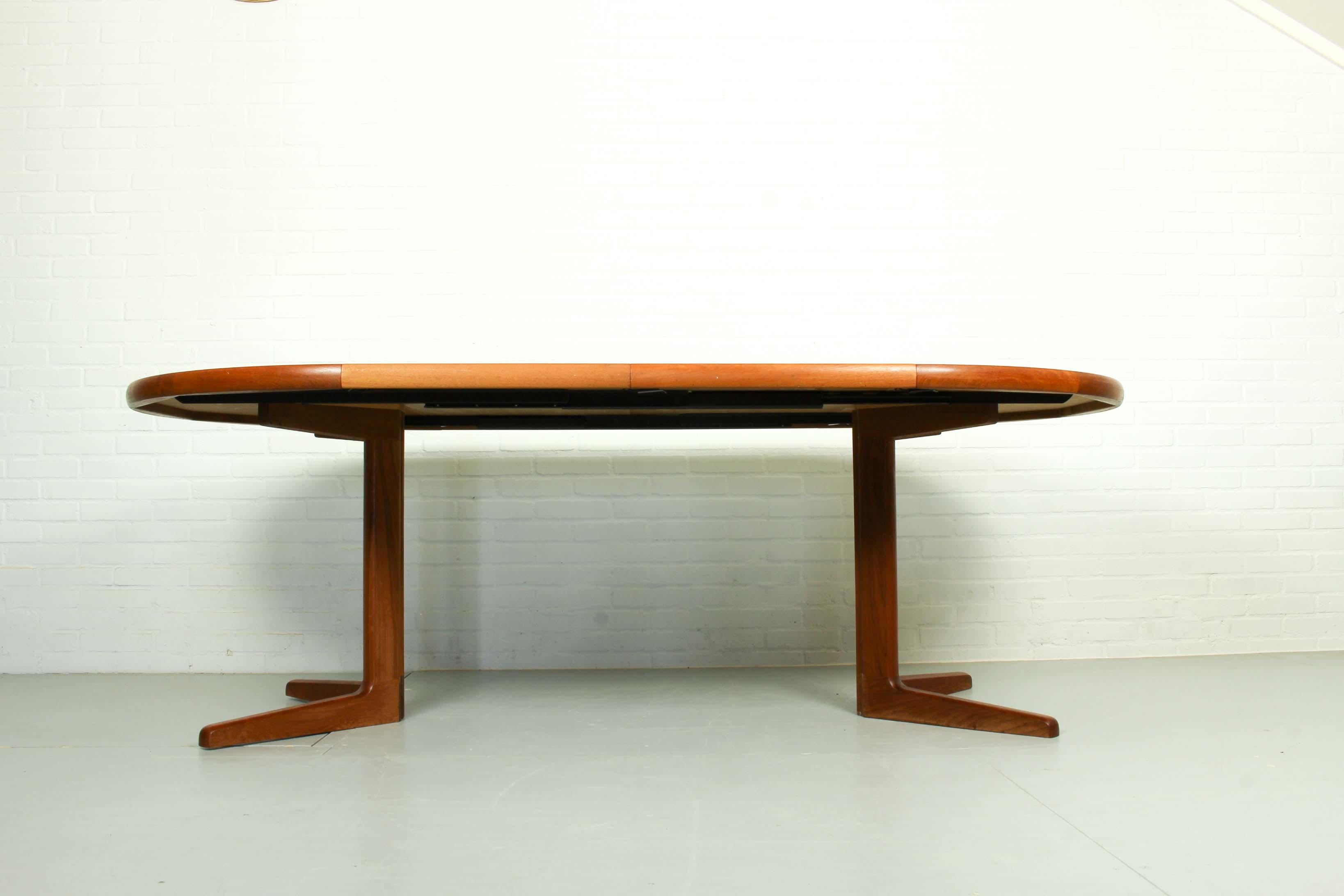 Midcentury teak expandable sculptural round dining table with 2 leaves, in the style of Valentinsen manufactured by Korup Stolefabrik. Made circa 1960 all teak with solid teak legs. Original finish in excellent condition. Stamped under table.