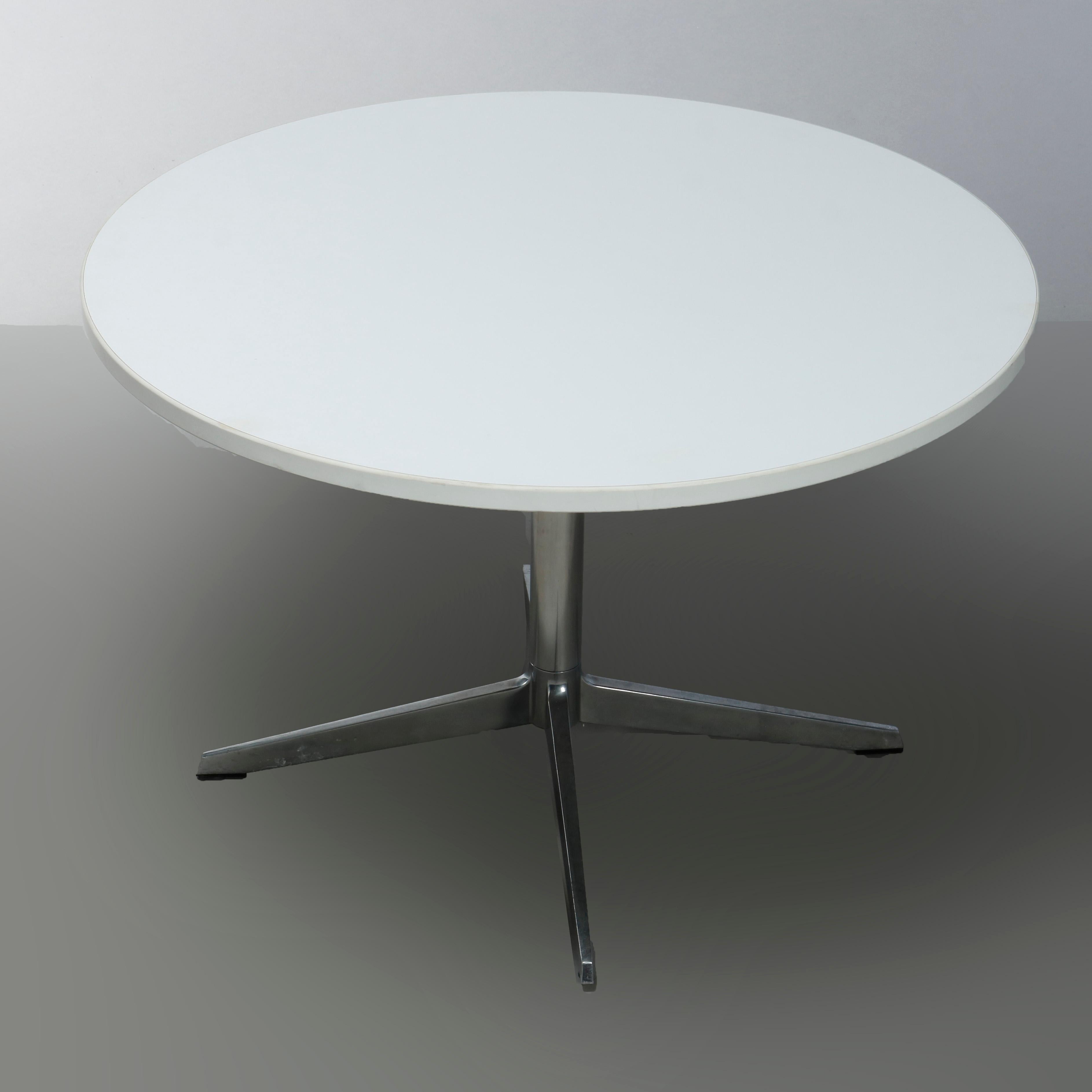 A Mid-Century Modern low table in the manner of Eames for Miller offers round top surmounting chromed steel base with central column having four feet, 20th century

Measures: 20.5