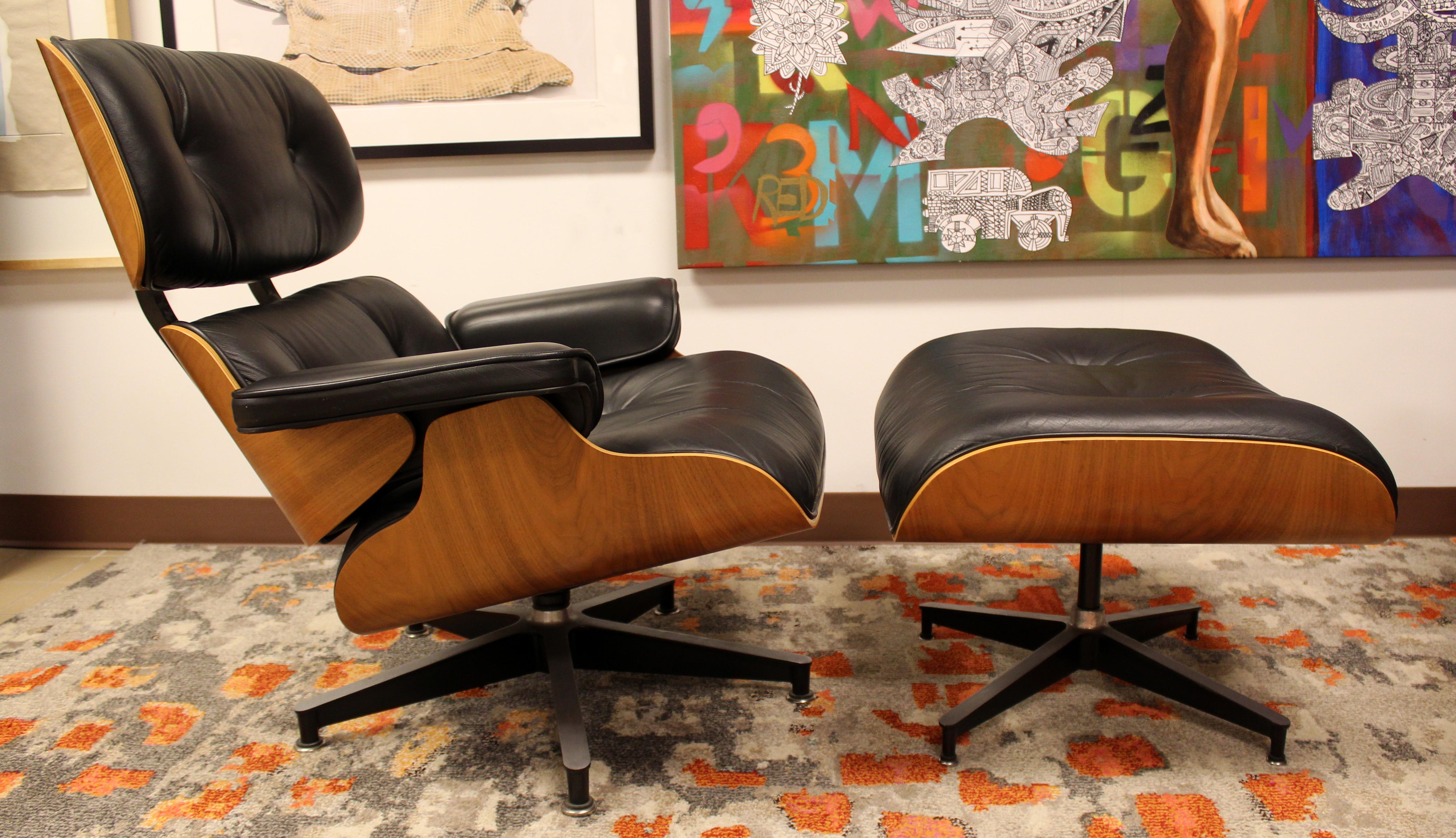 For your consideration is a marvelous, Charles Eames for Herman Miller iconic, walnut and black leather armchair and matching ottoman, circa 1980s. In excellent condition. The dimensions of the chair are 33