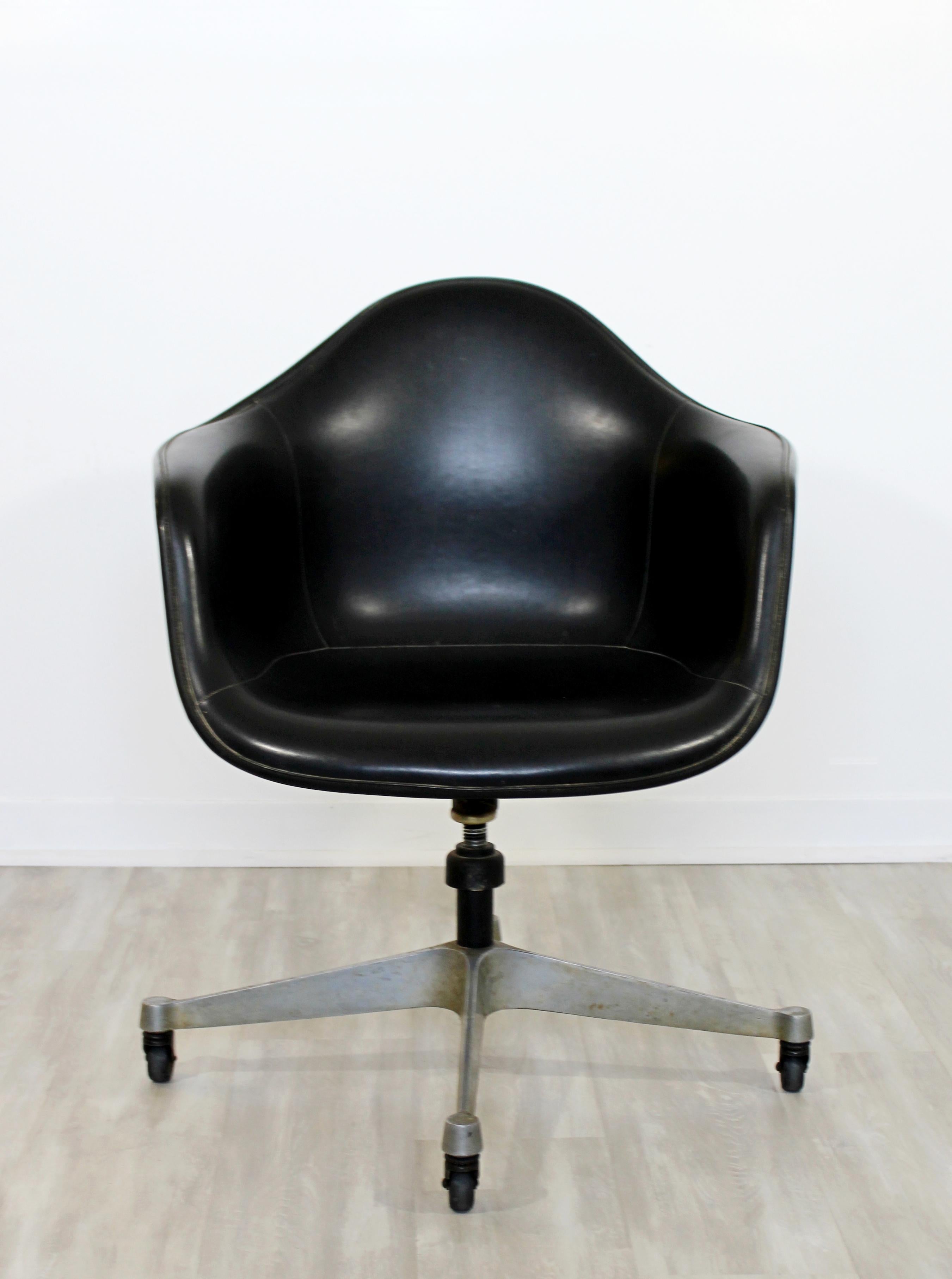 For your consideration is an original, fiberglass shell, swivel armchair, by Charles & Ray Eames for Herman Miller, circa the 1960s. Original tag reads 1968. In good vintage condition. The dimensions are 25