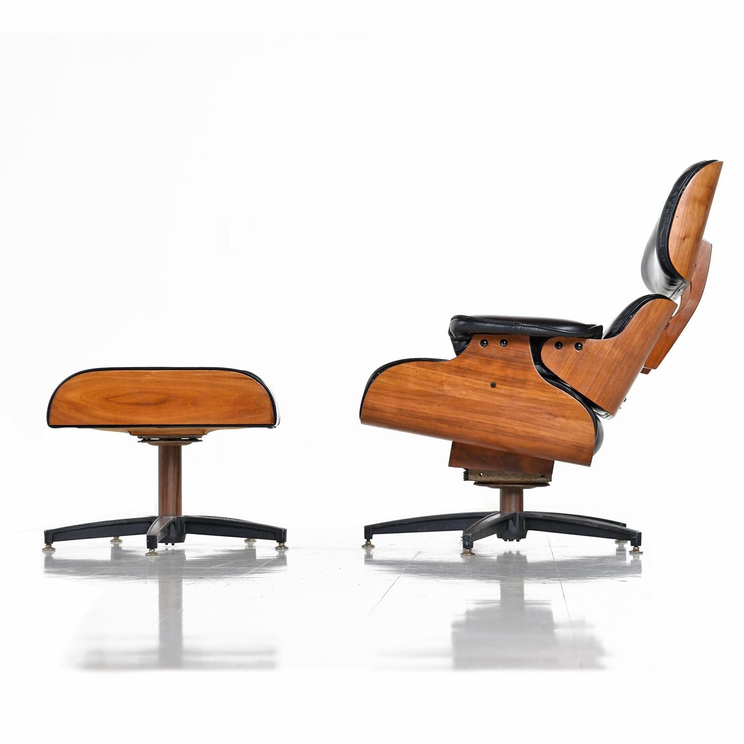 Mid-Century Modern Eames style lounge chair and matching ottoman made in Canada. Gorgeous tufted black vinyl, bentwood walnut frame, aluminum five-star base and adjustable spring action tension knob underneath the chair. What makes this chair unique
