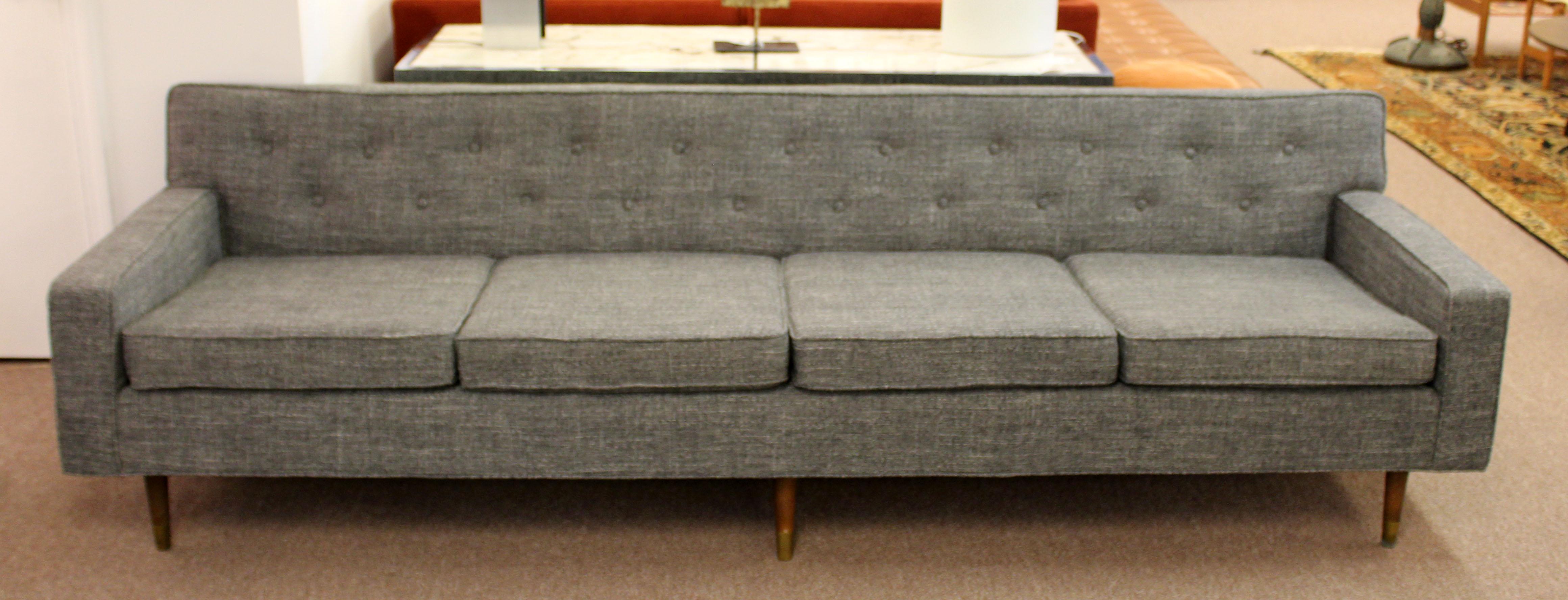 For your consideration is a marvelous long sofa, with a gray upholstery on walnut wood legs, by Milo Baughman for Thayer Coggin, circa the 1960s. In excellent condition. Recently professionally reupholstered in Knoll Fabric. The dimensions are 96