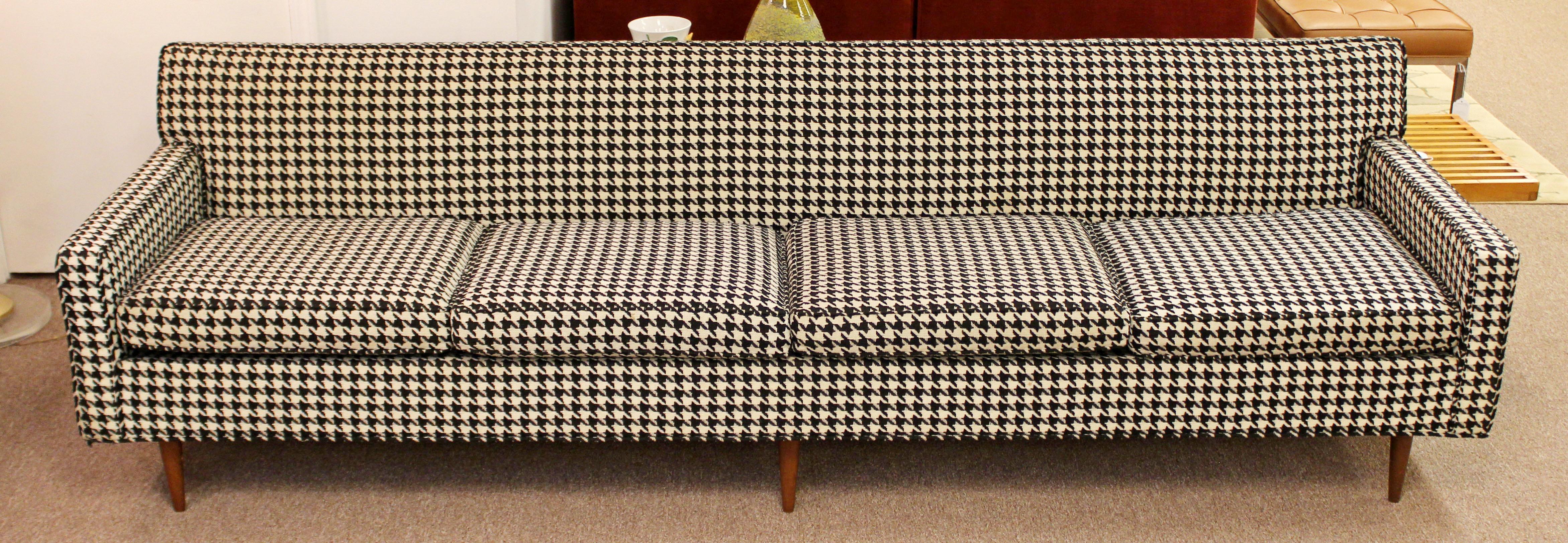 For your consideration is an incredible, early and rare, long sofa, with a houndstooth fabric, on wooden legs, by Milo Baughman, for Thayer Coggin, circa the 1960s. In very good condition. The dimensions are 96.5