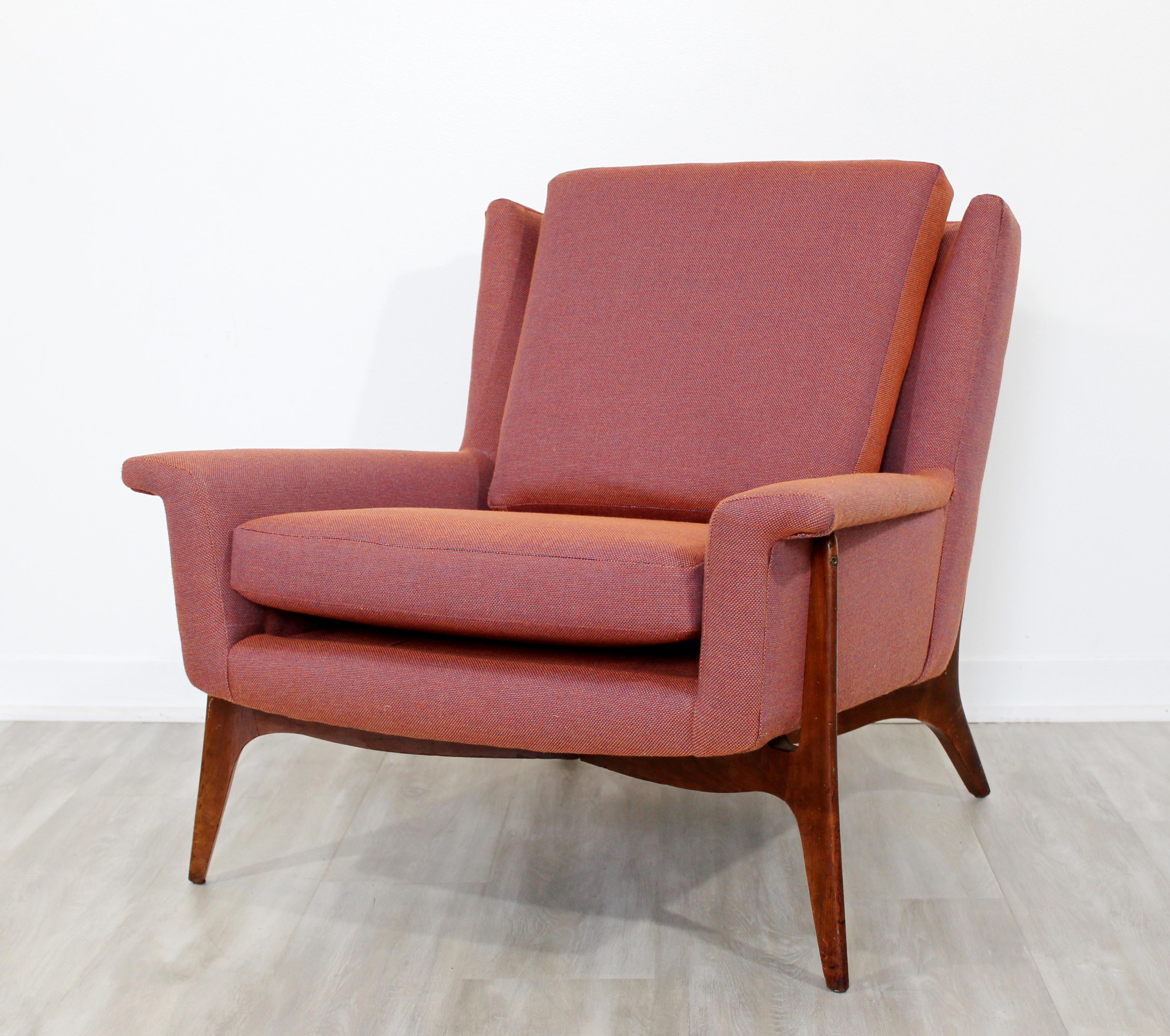 For your consideration is a stunningly angled, lounge armchair, with a wood base and new upholstery, lounge chair, circa the 1950s. In excellent vintage condition. The dimensions are 31.5