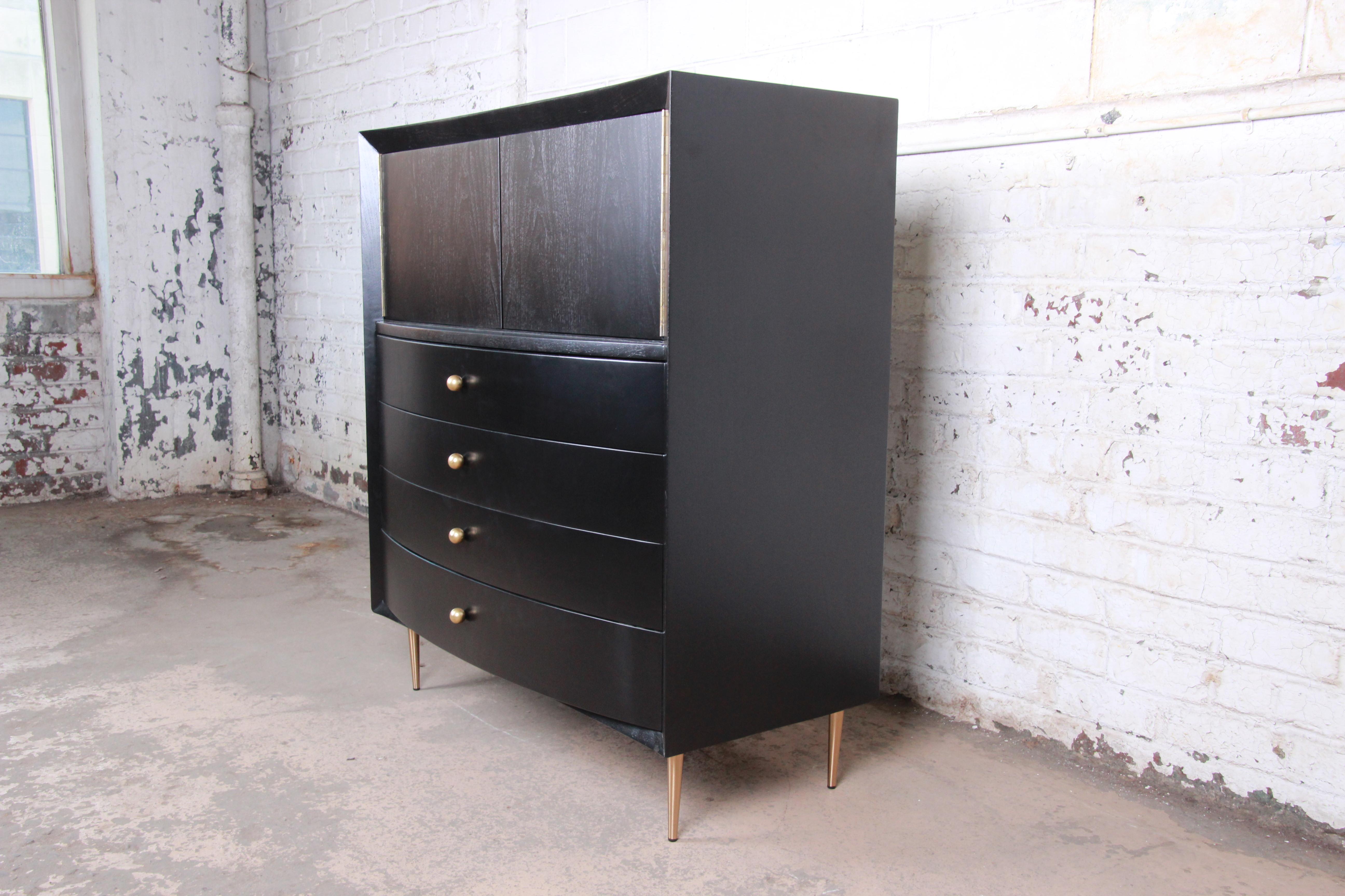 An exceptional Mid-Century Modern Hollywood Regency ebonized bow front gentleman's chest

By Robert Lewis Mfg. Co.

USA, 1950s

Ebonized walnut, with brass hardware and legs.

Measures: 46
