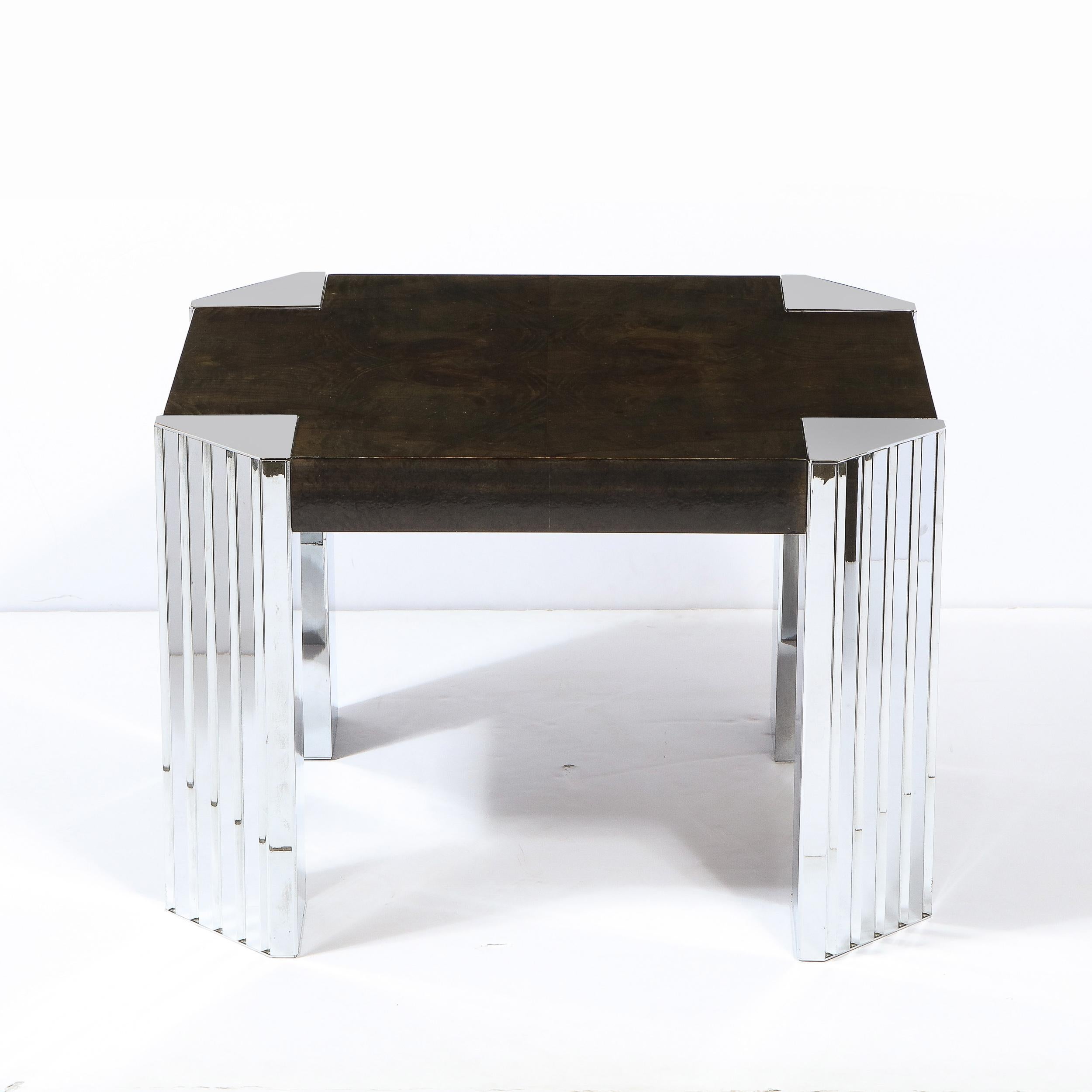 This stunning Mid-Century Modernist table in burled bookmatched and ebonized walnut was realized by in the United States circa 1970. It features beveled corners with triangular chrome inserts which attach to reeded chrome legs. With its austere form