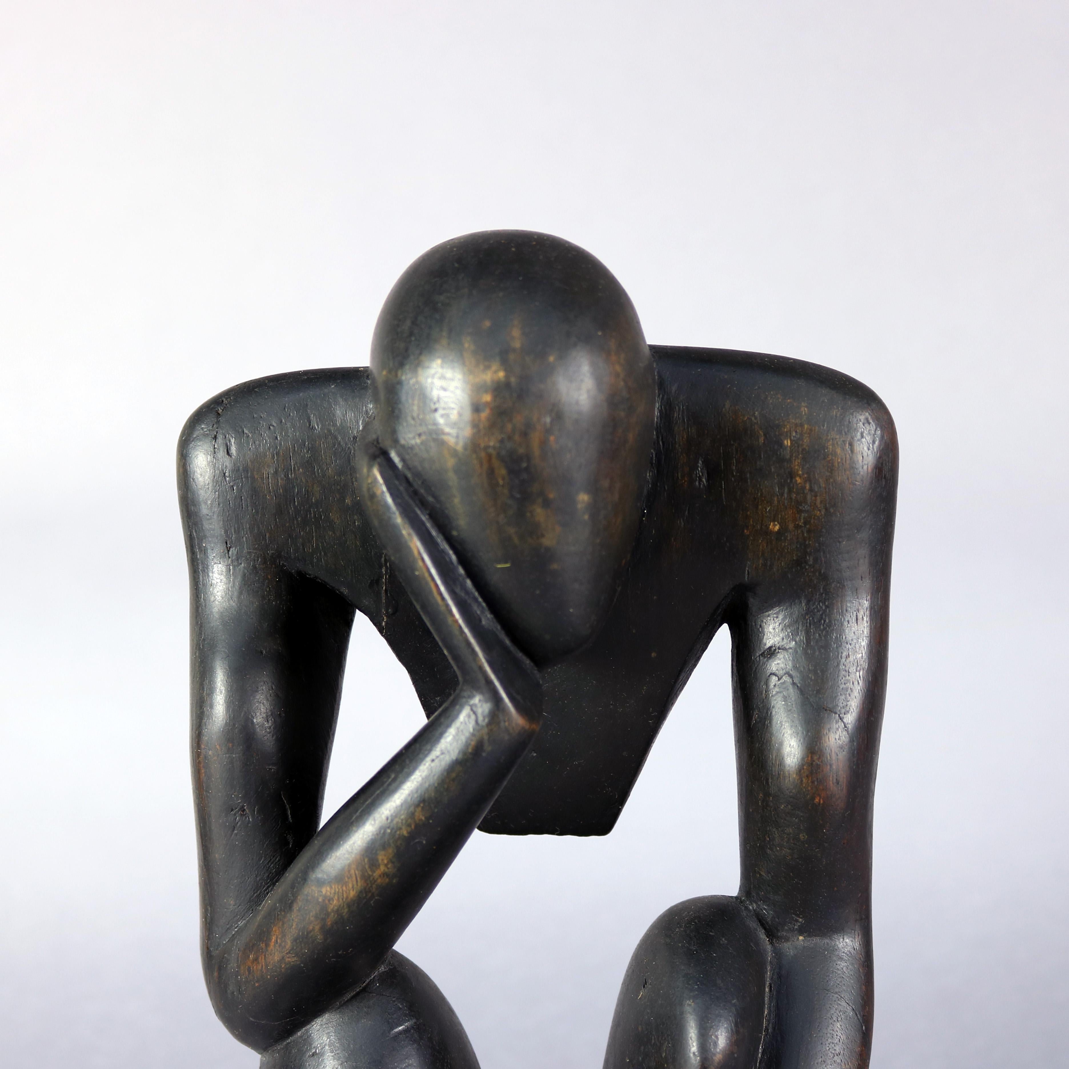 Mid-Century Modern sculpture features ebonized abstract figural carved wood thinking man, interpretation of 