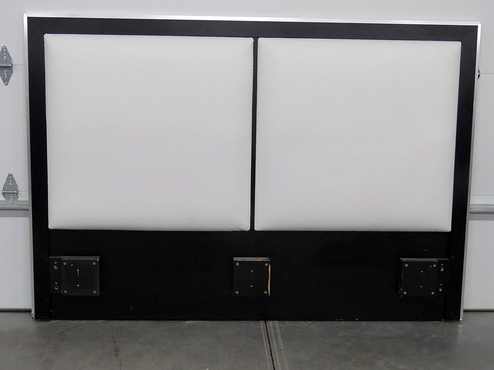 Mid-Century Modern ebonized headboard with leather upholstery and chrome trim.