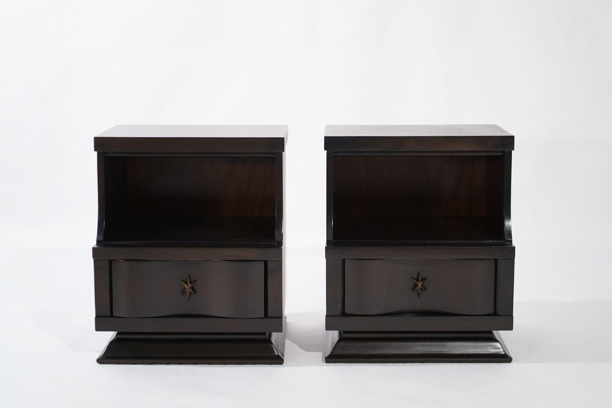 Elevate your bedroom aesthetic with Stamford Modern's impeccably restored pair of 1950s nightstands, exquisitely crafted from mahogany and transformed with a sleek ebony finish. The deep, rich tones of the wood, combined with meticulous restoration,