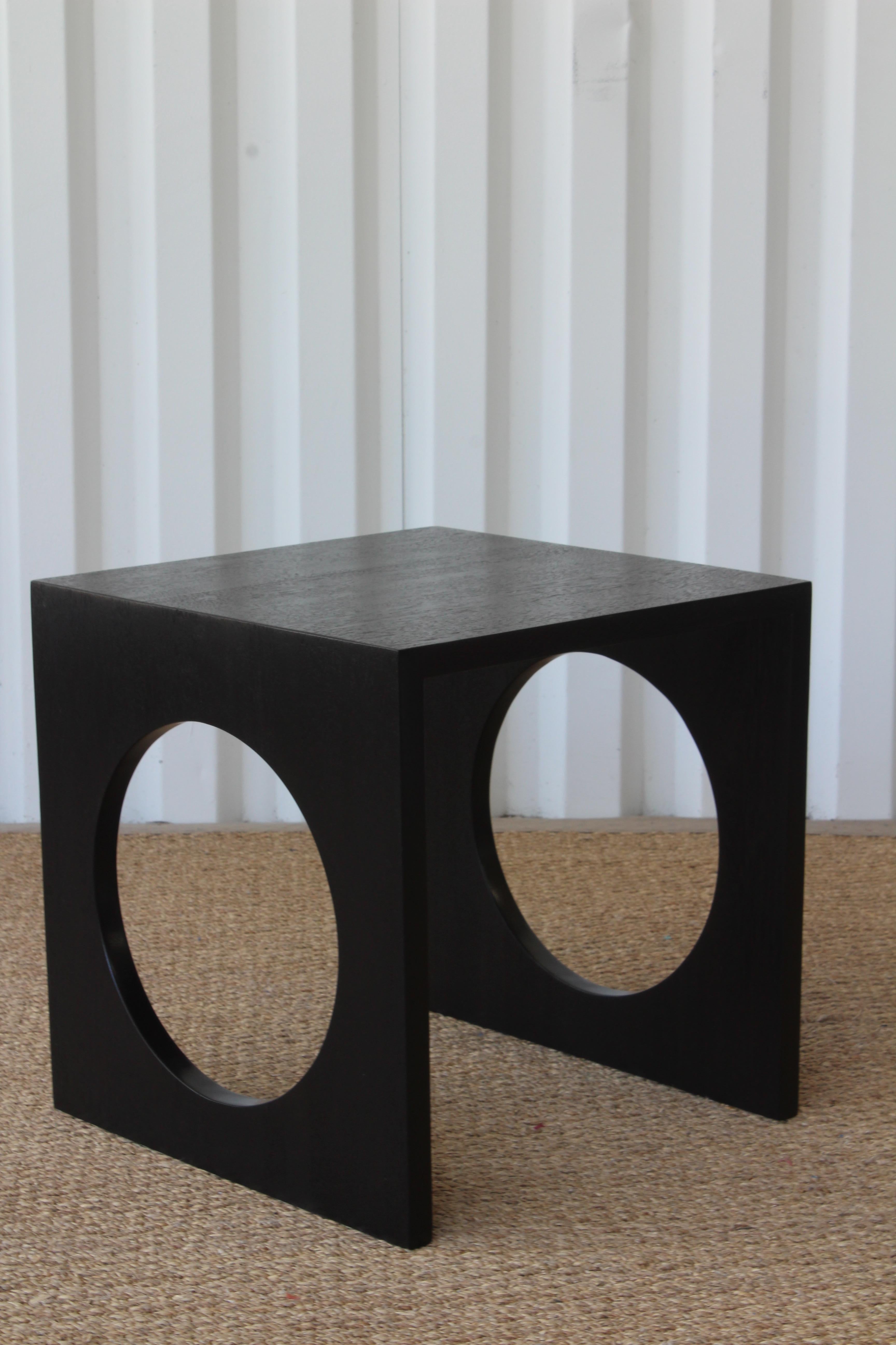 Vintage 1960s side table with circle cutout, made from solid oak. Recently refinished in satin black.