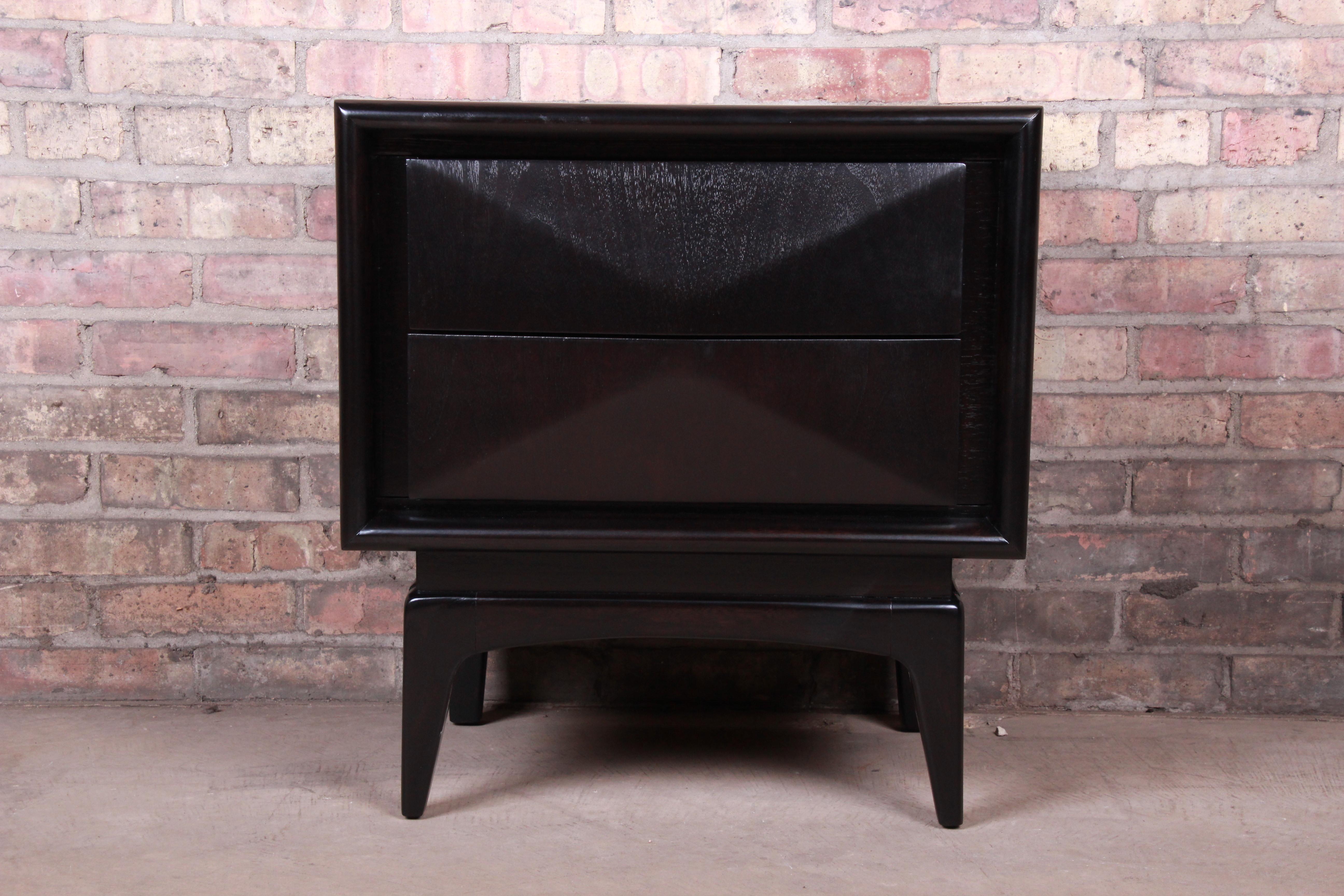 A stunning Mid-Century Modern diamond front nightstand

In the manner of Vladimir Kagan

By United Furniture Co.

USA, 1960s

Ebonized walnut, with unique sculpted diamond front design.

Measures: 23