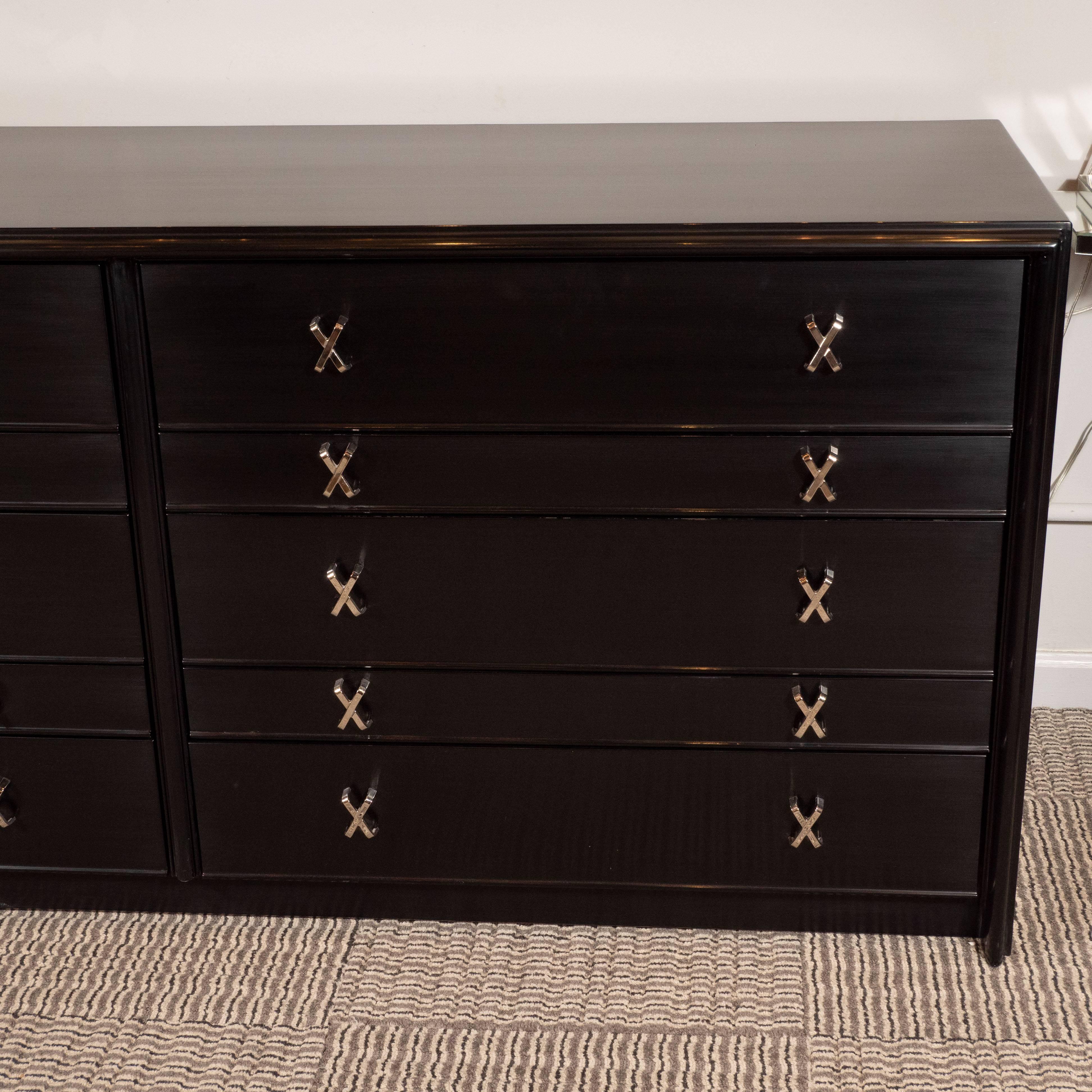 This stunning and elegant chest of drawers was realized by the fabled 20th century designer, Paul Frankl, for John Stuart Inc., circa 1950. It features ten drawers- three taller and two shorter with three compartments in each. The drawers feature a