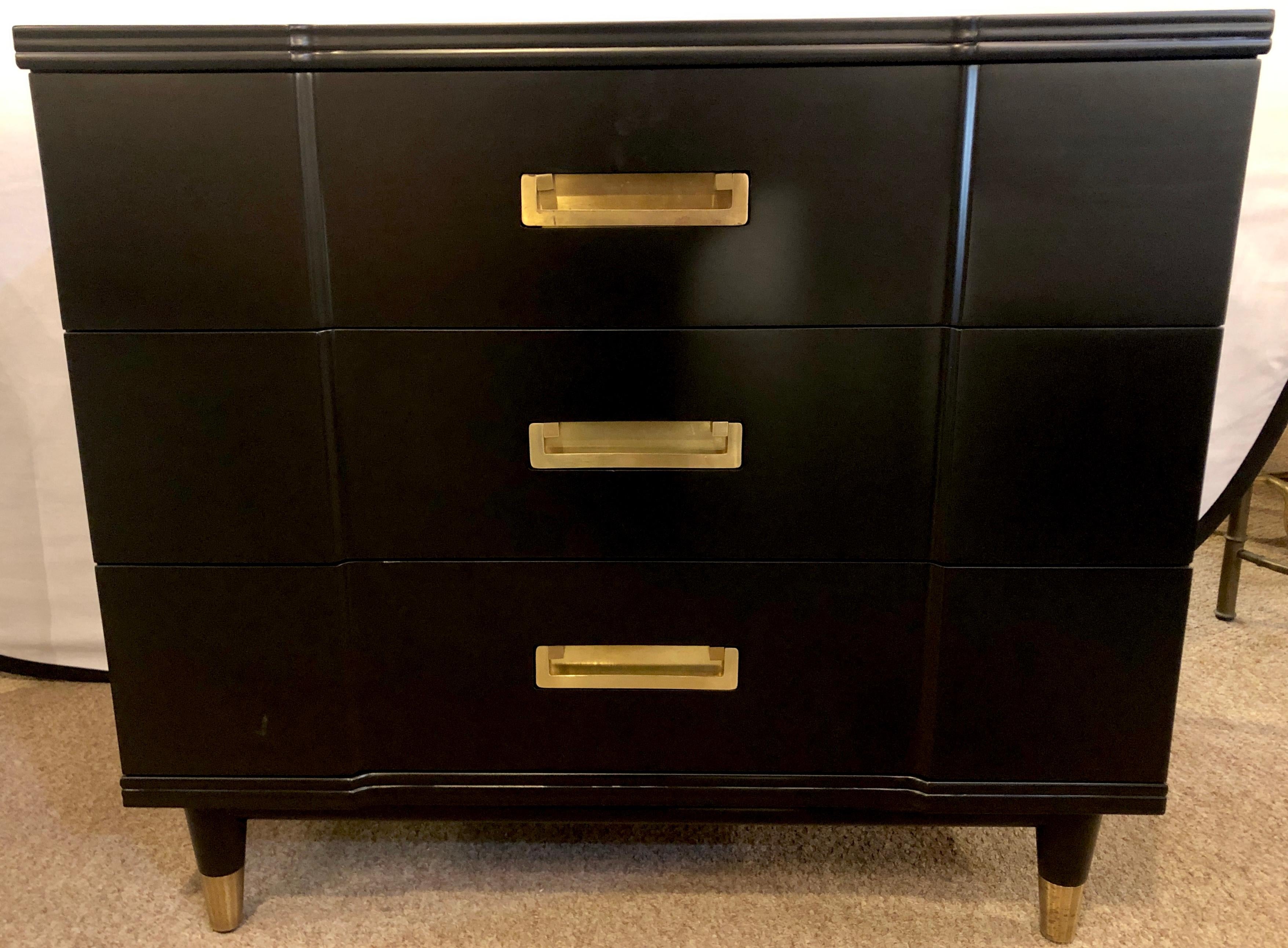 Mid-Century Modern ebony Widdicomb Campaign chests, commodes or night tables with hidden hardware. These sleek and stylish recently refinished chests having bronze hide a way drawer pulls and bronze sabots on an all ebony finish. The pair having