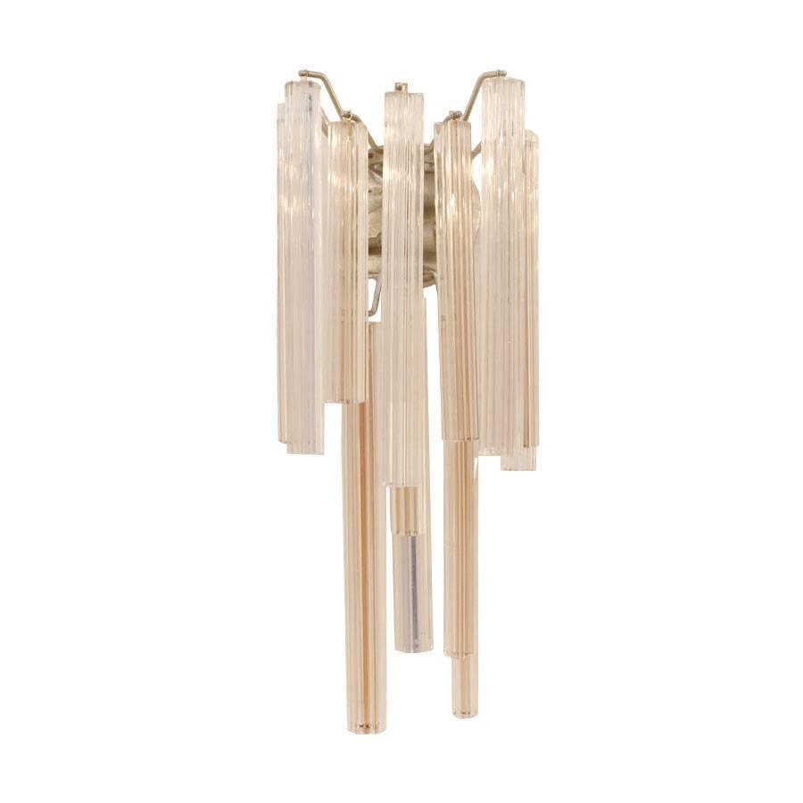Pair of sconces edited and signed by Venini. Composed of 15 different solid crystal pieces disposed in two layers. 
Wall-mounted metal frame and each requires two light bulbs, Italy, 1960.